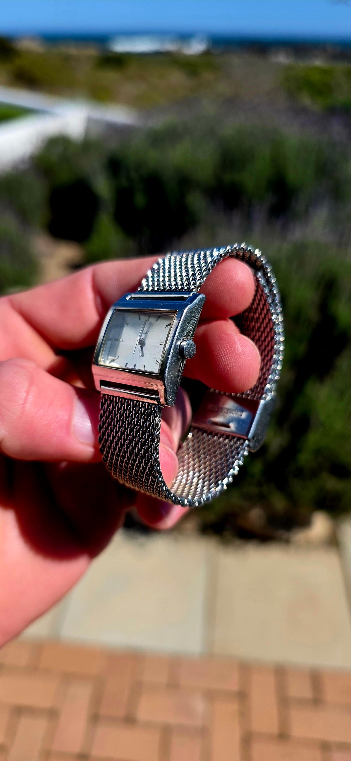 Oh this is wonderfully RETRO! A vintage ladies GUESS Mod-Mesh quartz wristwatch, combining a sleek rectangular case with a fabulous wide silver-tone woven mesh bracelet — giving it that unmistakable minimalist designer look.