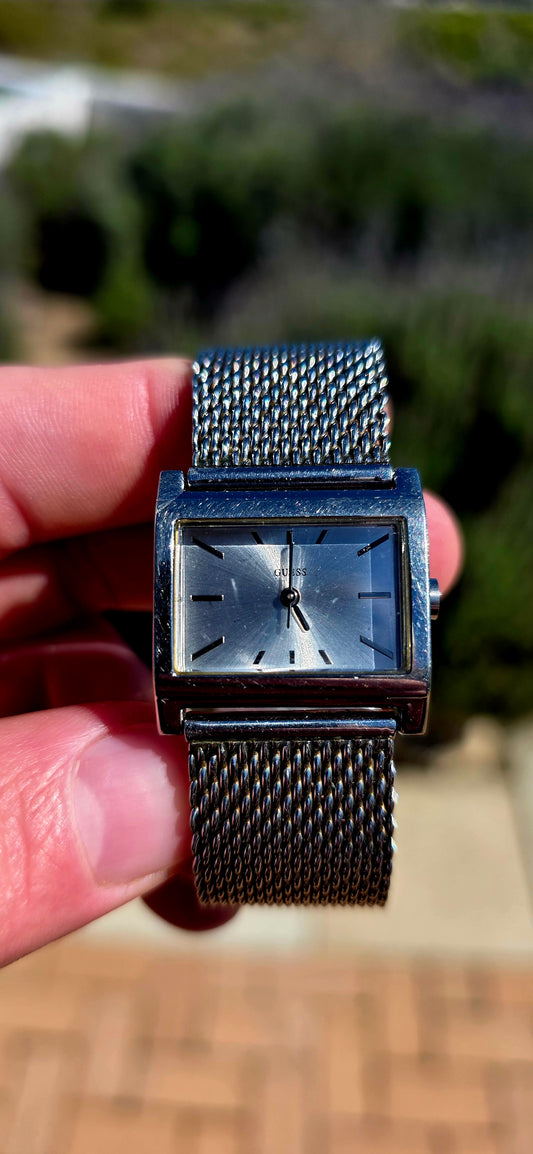 Oh this is wonderfully RETRO! A vintage ladies GUESS Mod-Mesh quartz wristwatch, combining a sleek rectangular case with a fabulous wide silver-tone woven mesh bracelet — giving it that unmistakable minimalist designer look.