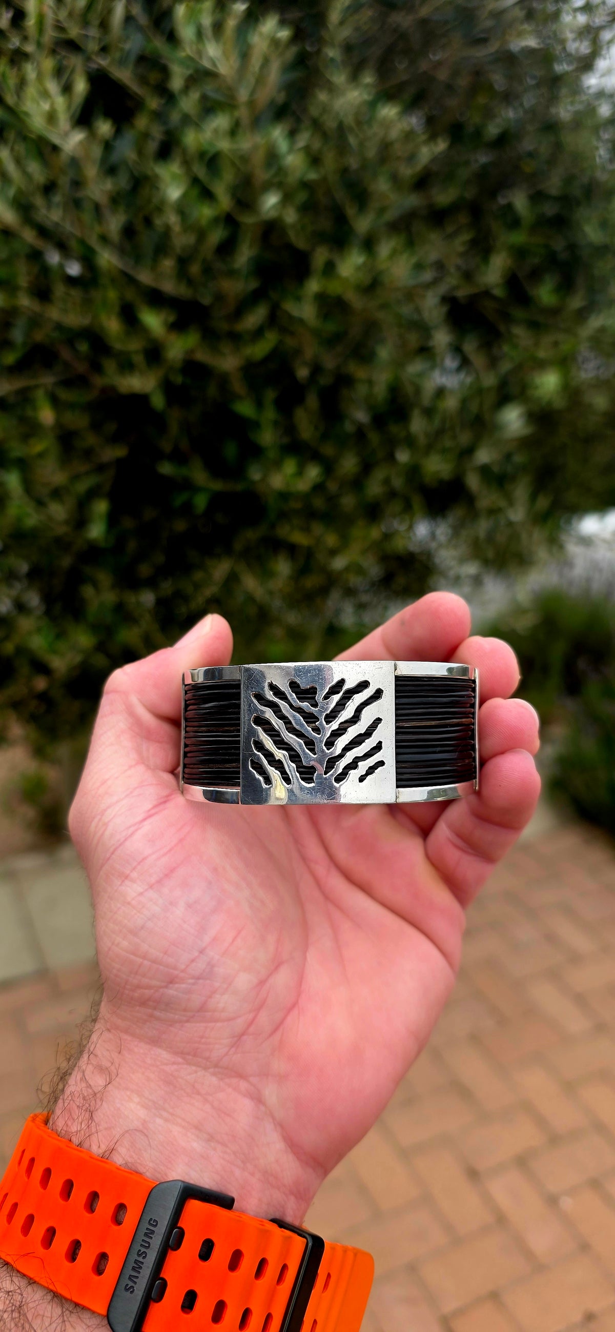 Bold, wonderfully tactile and perfectly UNISEX — this chunky open cuff bracelet combines polished sterling silver with multiple strands of genuine elephant hair, creating a striking contrast between the cool silver and rich dark natural fibres.