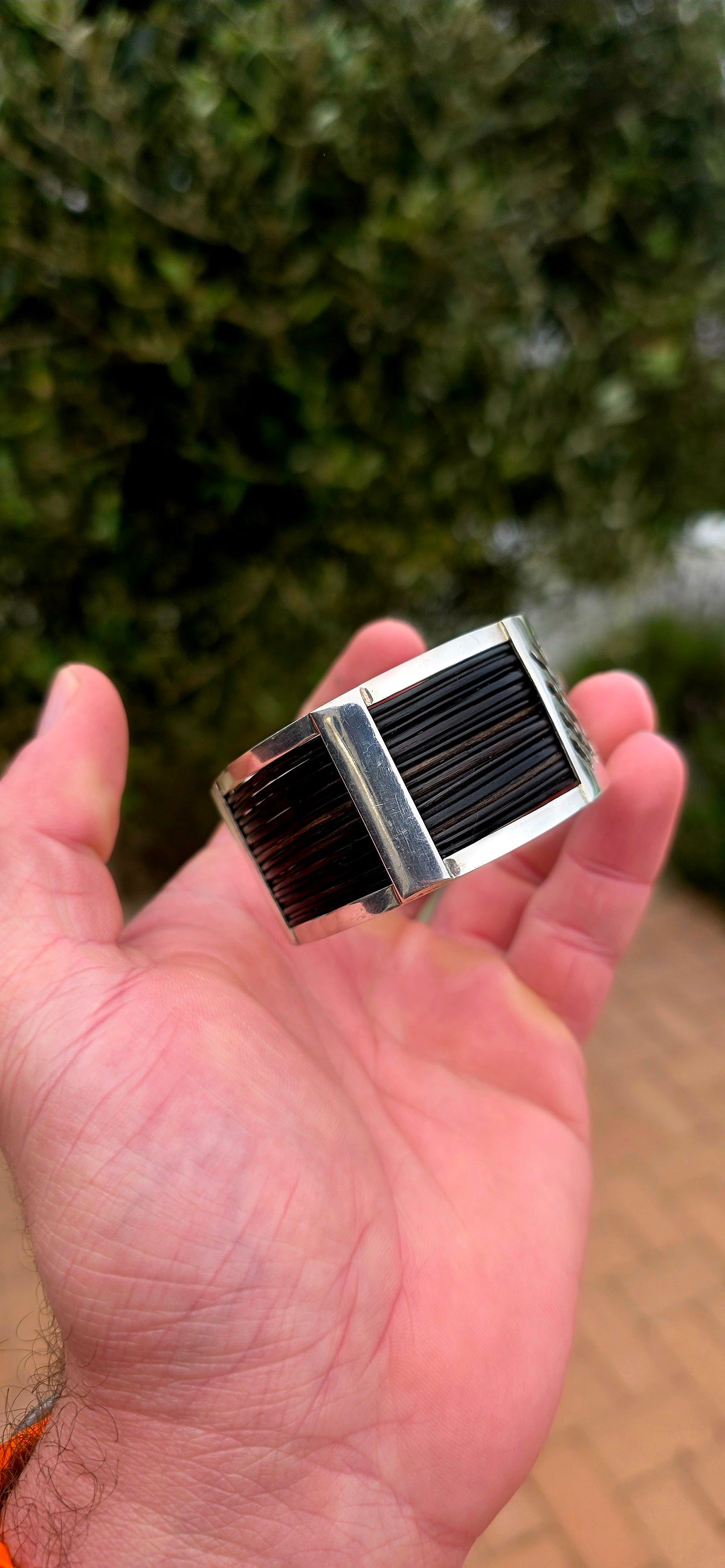 Bold, wonderfully tactile and perfectly UNISEX — this chunky open cuff bracelet combines polished sterling silver with multiple strands of genuine elephant hair, creating a striking contrast between the cool silver and rich dark natural fibres.