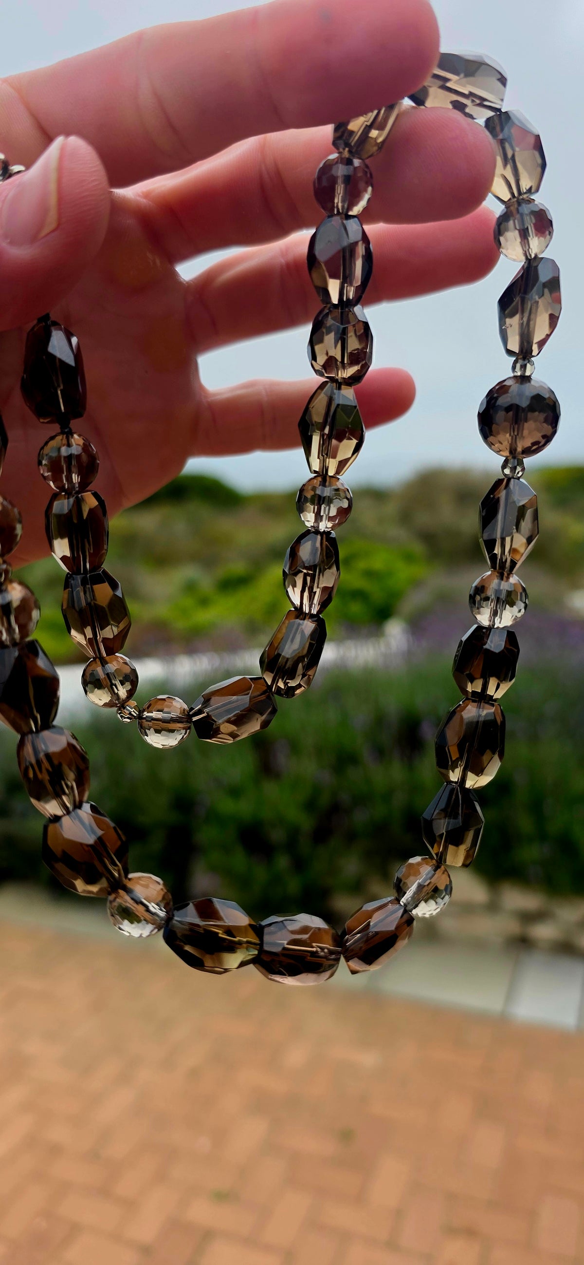 Beautifully and earthy! This necklace is composed entirely of natural smoky quartz gemstone beads, individually faceted to catch and reflect the light.