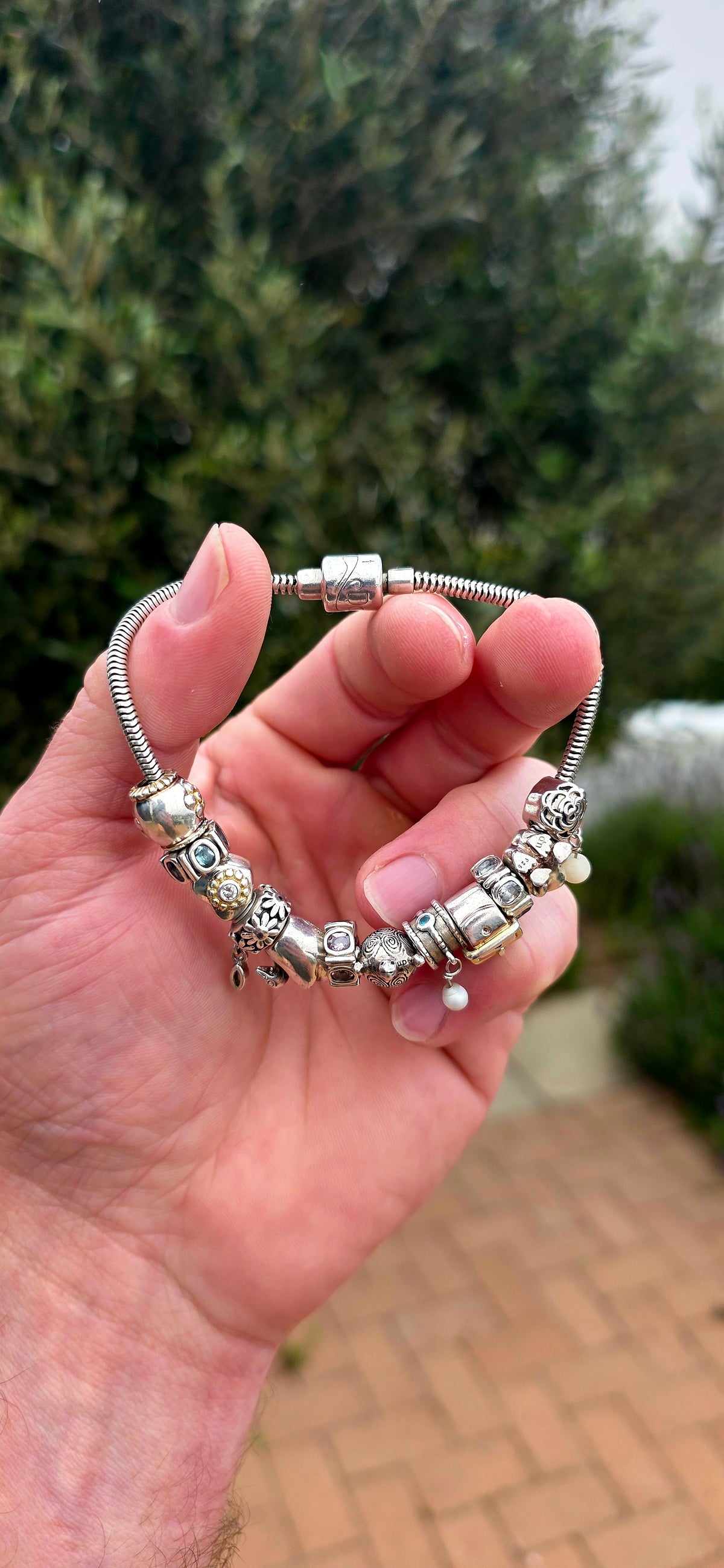 A wonderfully playful designer Donna Mia sterling silver charm bracelet, absolutely LOADED with personality!