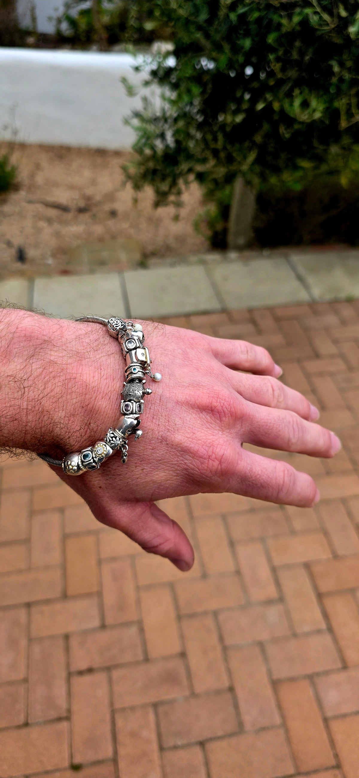 A wonderfully playful designer Donna Mia sterling silver charm bracelet, absolutely LOADED with personality!