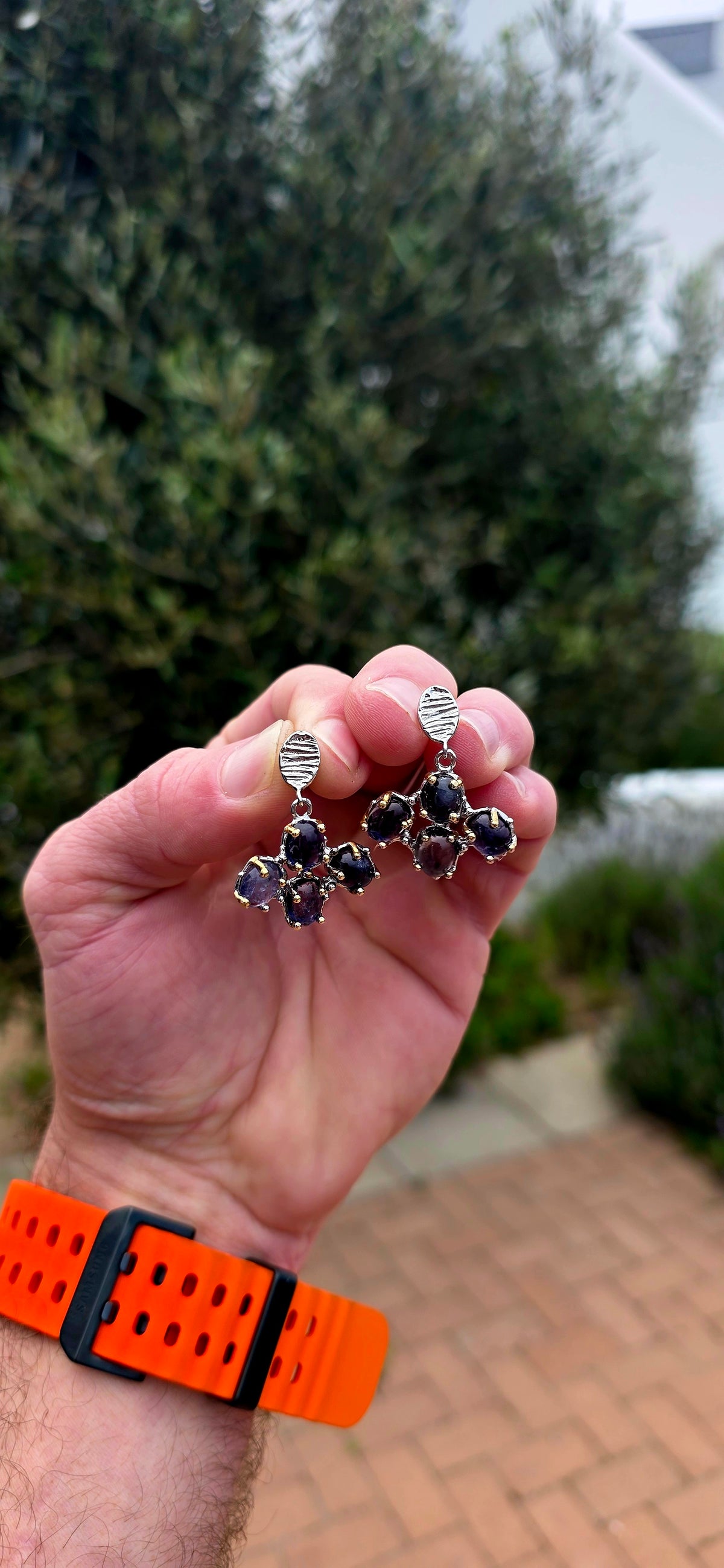 Handcrafted in sterling silver, these artisan drop earrings feature clusters of generously sized oval iolite cabochons, creating a beautifully organic floral formation beneath textured oval stud tops.