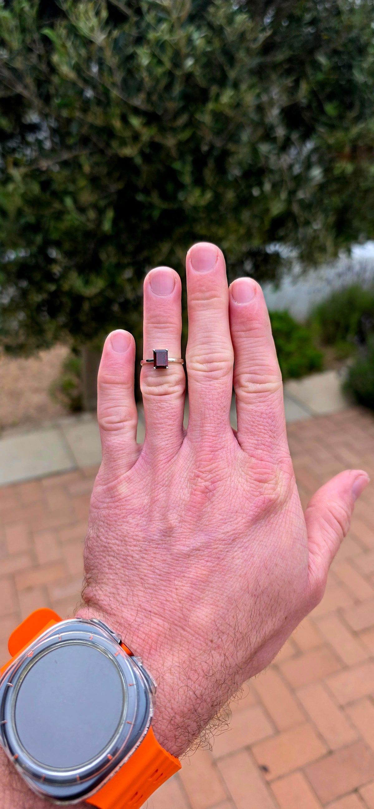 Clean, classical and beautifully elegant! This sterling silver solitaire ring features a gorgeous emerald-cut garnet.