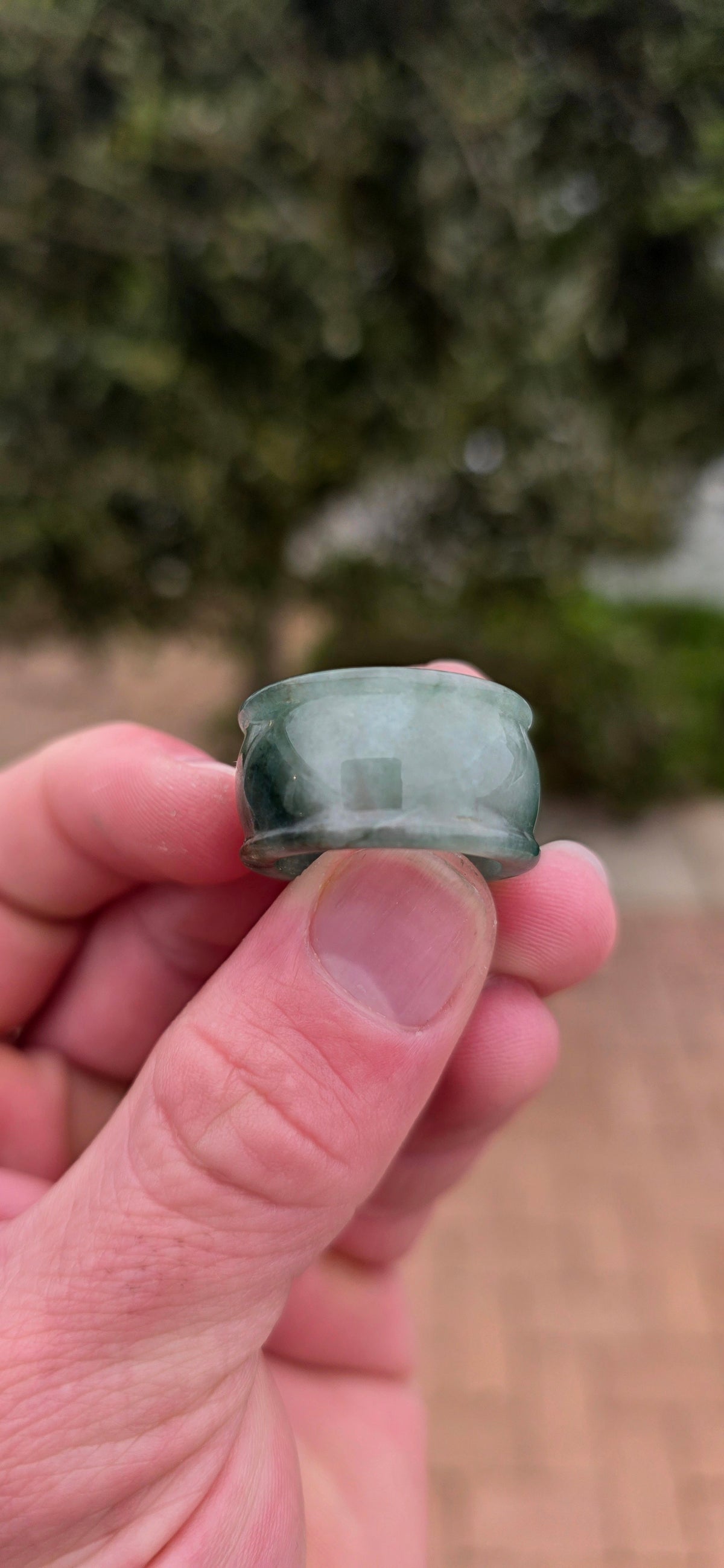 A wonderfully chunky unisex jade saddle ring, carved entirely from a single solid piece of natural green and white jade.