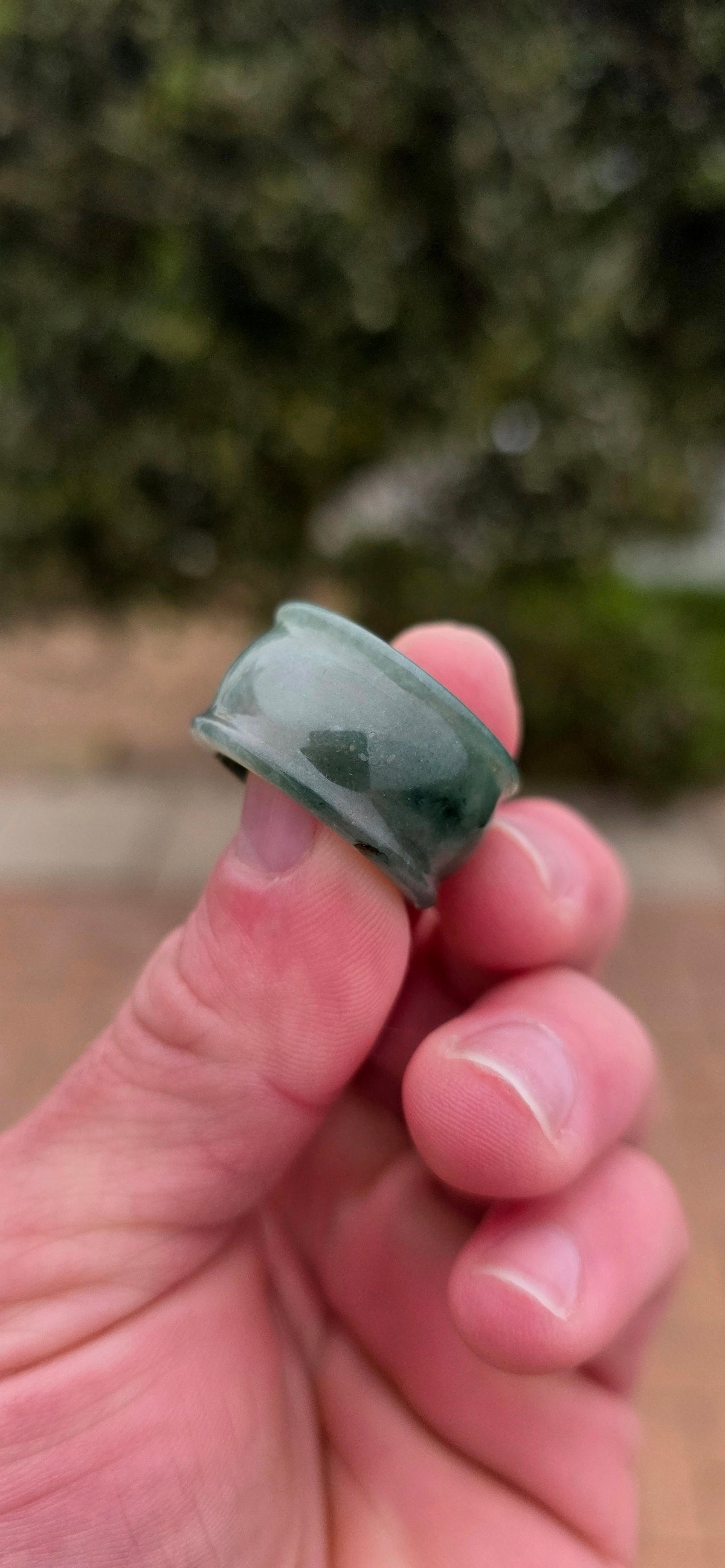 A wonderfully chunky unisex jade saddle ring, carved entirely from a single solid piece of natural green and white jade.