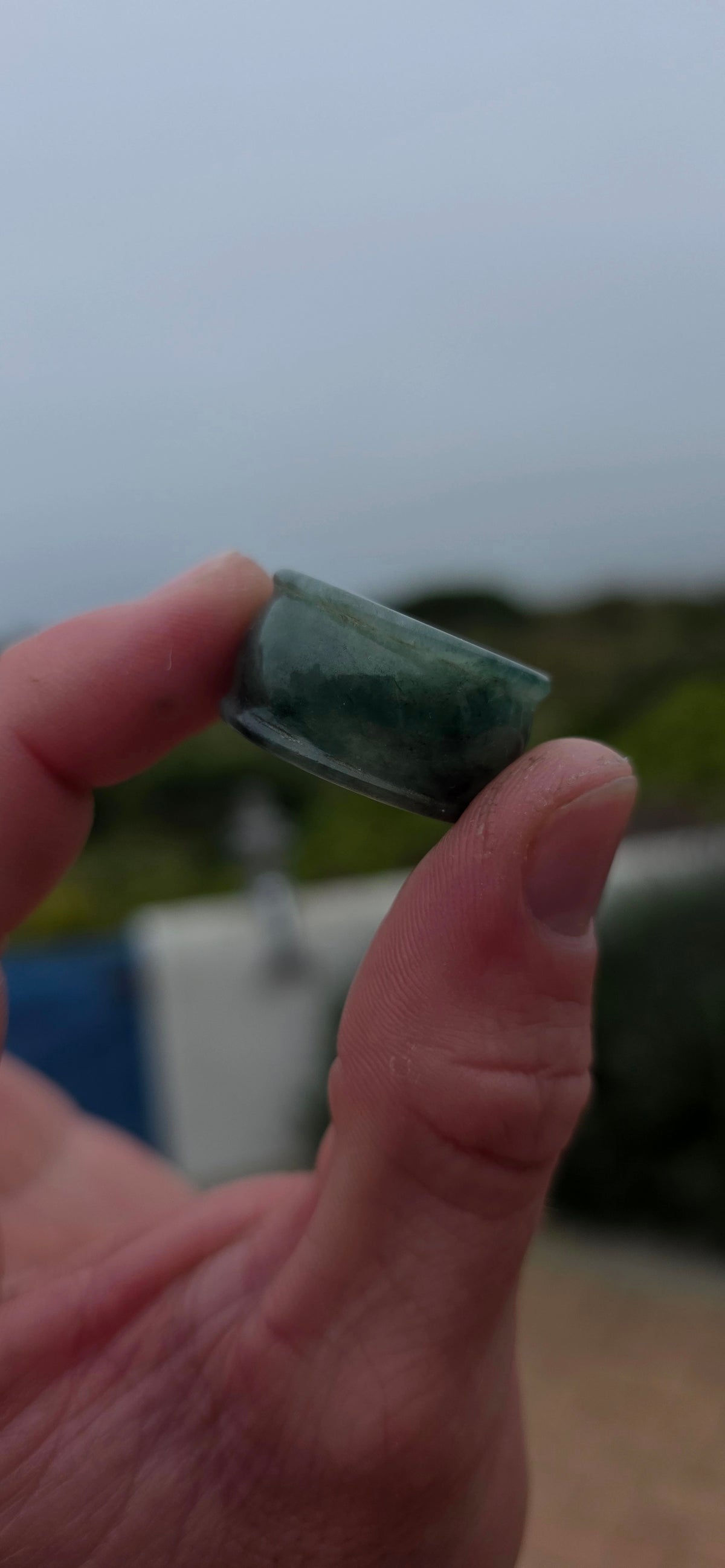 A wonderfully chunky unisex jade saddle ring, carved entirely from a single solid piece of natural green and white jade.