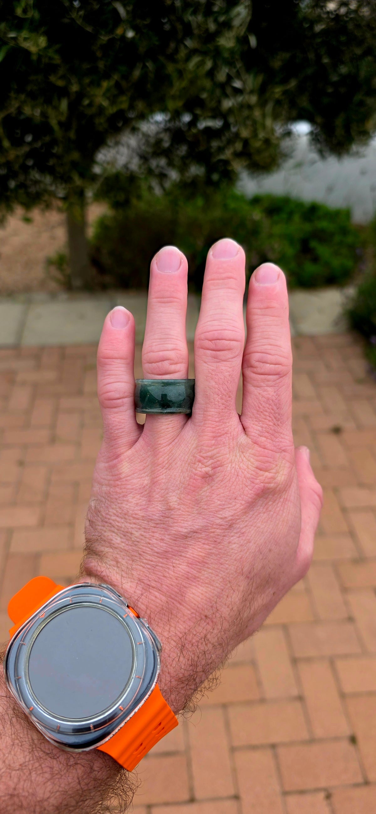 A wonderfully chunky unisex jade saddle ring, carved entirely from a single solid piece of natural green and white jade.