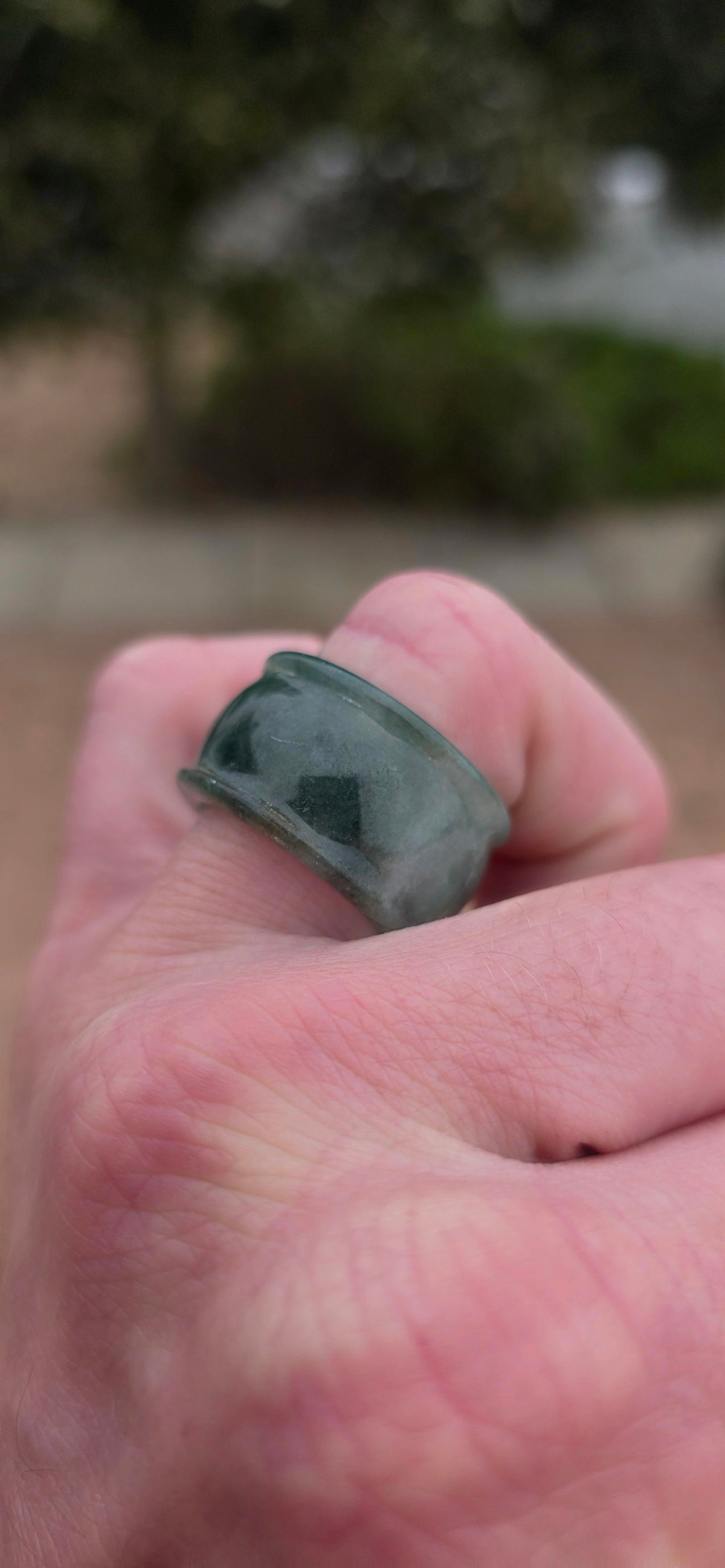 A wonderfully chunky unisex jade saddle ring, carved entirely from a single solid piece of natural green and white jade.