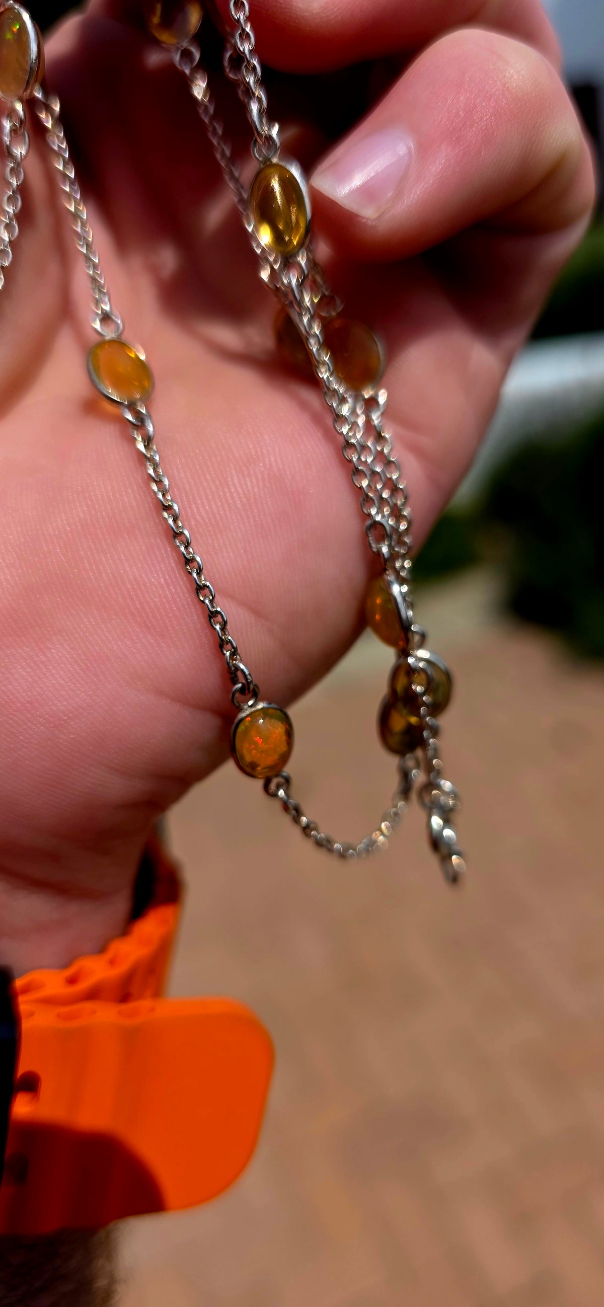 A gorgeous and elegant extra-length Sterling Silver station necklace, beautifully set with 16 oval translucent Ethiopian Welo Opal cabochons, individually bezel/tube set at intervals along the fine silver chain.