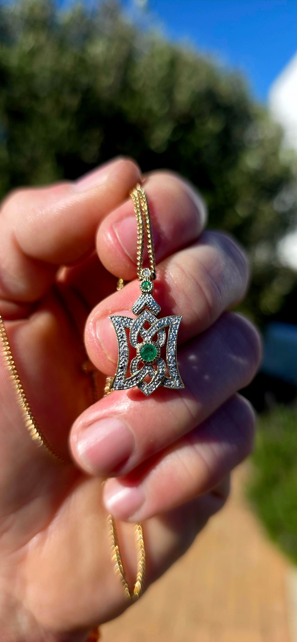 An elegant Art Deco Revival pendant, beautifully crafted in Sterling Silver with 18ct Yellow Gold plating, featuring Emeralds and sparkling clear CZ gemstones.