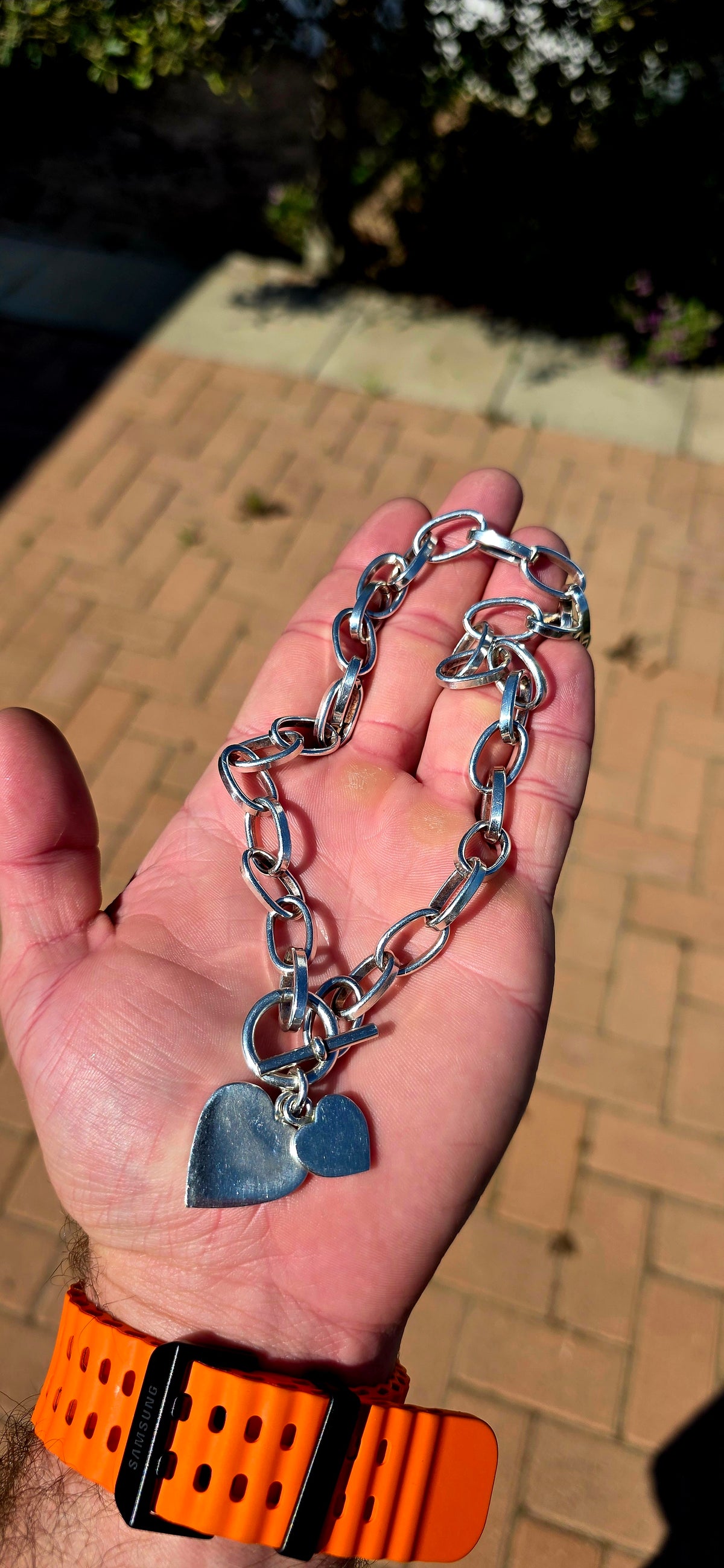A gorgeous handmade solid Sterling Silver necklace, constructed from substantial alternating elongated oval links with beautifully flattened, almost faceted edges .