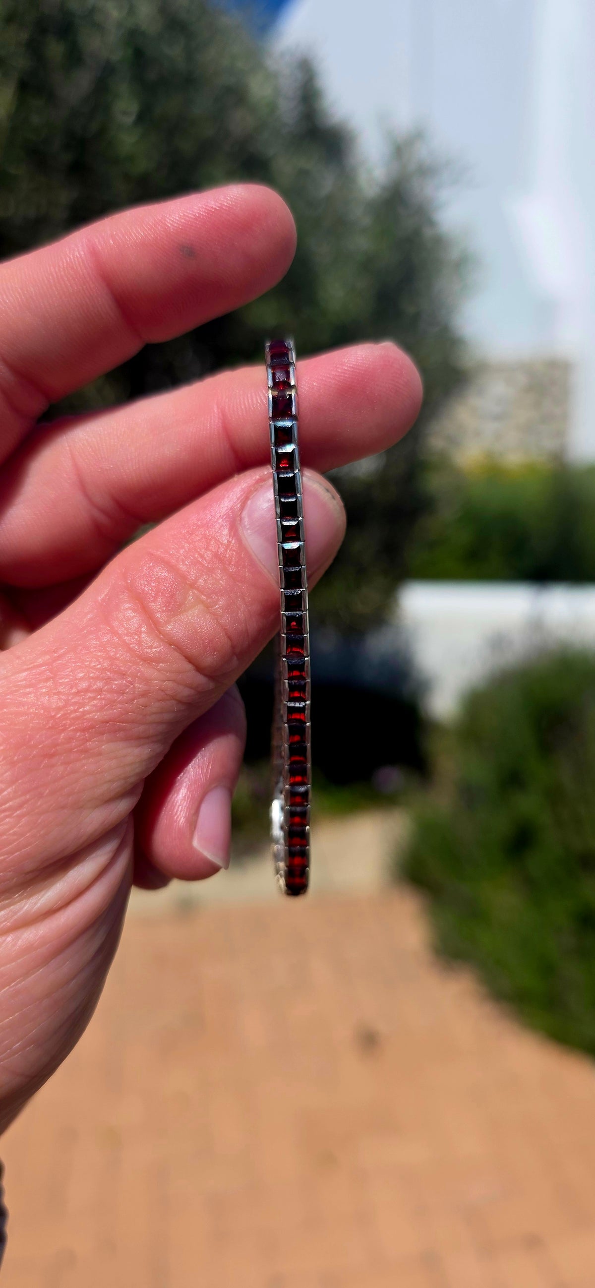 A wonderfully sleek vintage UNISEX sterling silver tennis bracelet, completely set with an impressive 56 deep-red garnets.