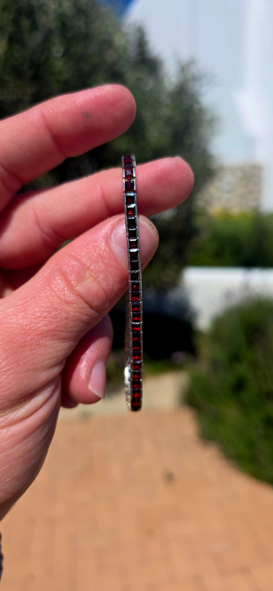 A wonderfully sleek vintage UNISEX sterling silver tennis bracelet, completely set with an impressive 56 deep-red garnets.
