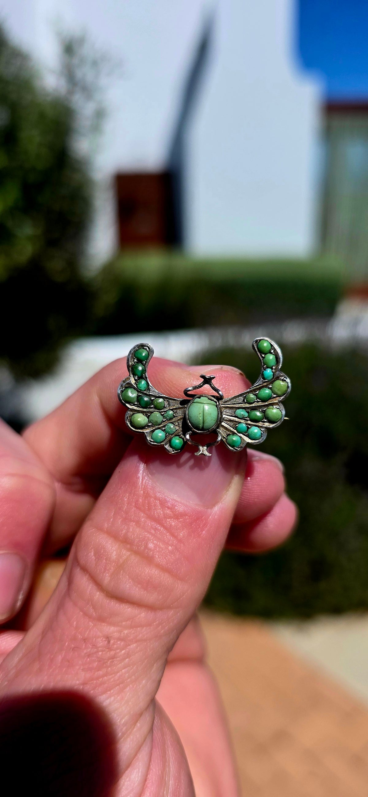 An antique late Victorian Egyptian Revival brooch, crafted in sterling silver and designed as a magnificent winged scarab.