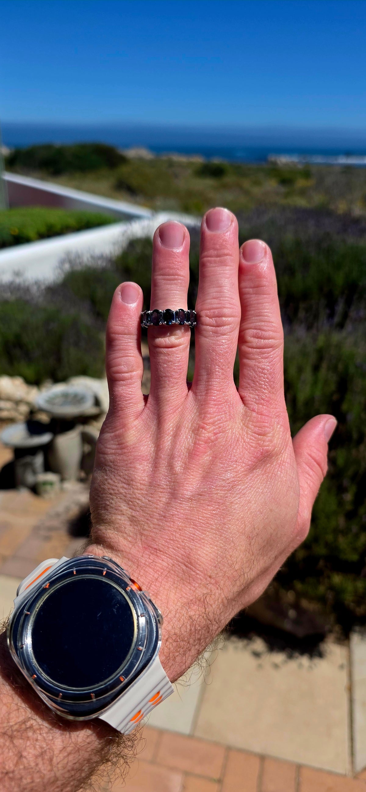 A gorgeous sterling silver full eternity stacking ring, set all the way around with 13 generously sized oval-cut London Blue Topaz gemstones.