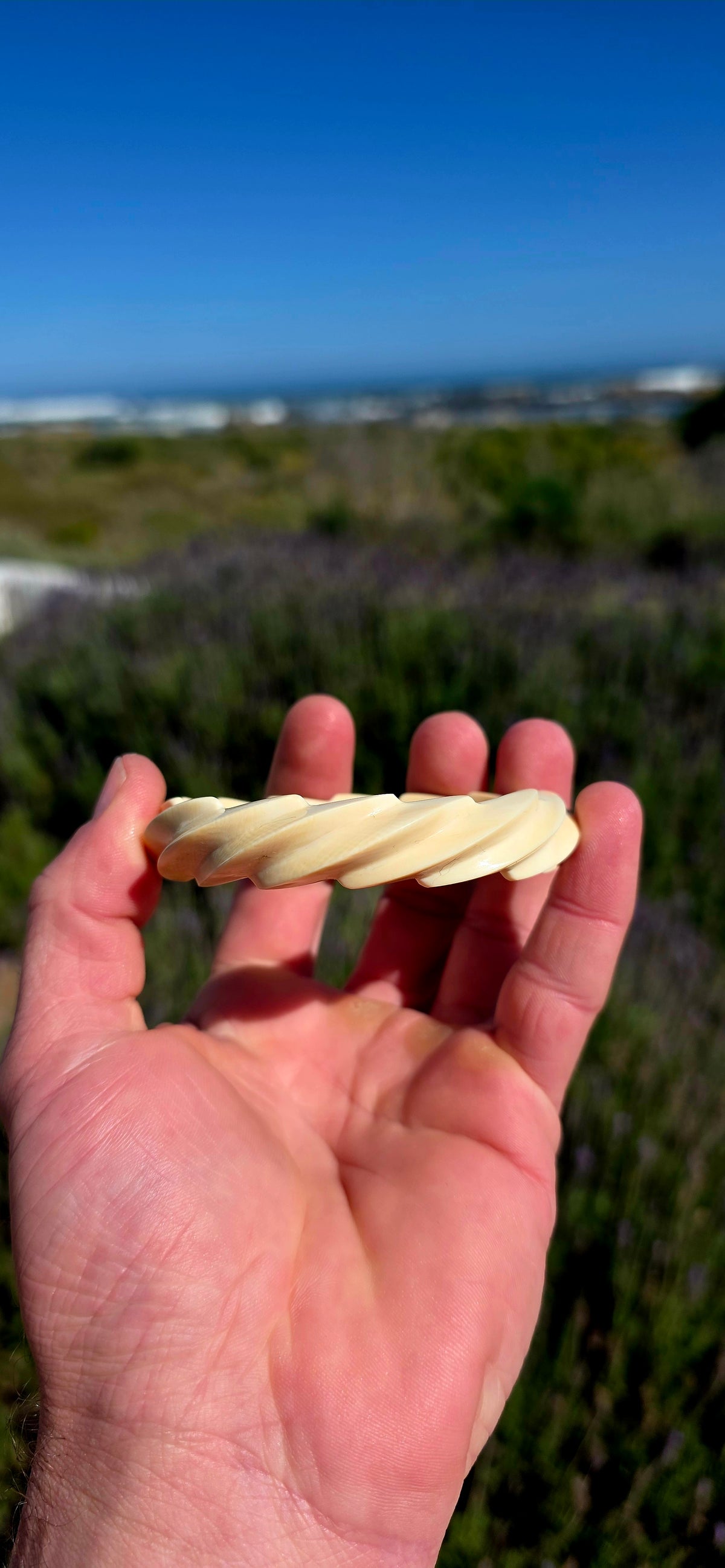This substantial pre-ban ivory bangle has been expertly hand-carved from a single piece of ivory into a fabulous continuous twisted spiral design, creating the illusion of overlapping ribbons wrapping around the wrist.