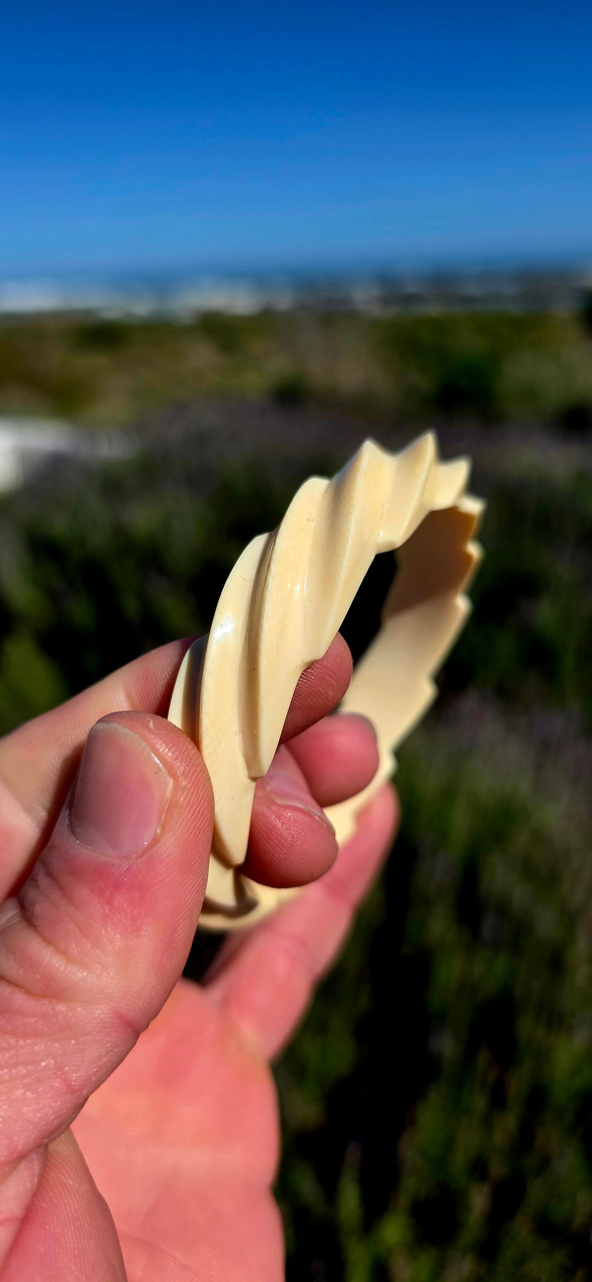 This substantial pre-ban ivory bangle has been expertly hand-carved from a single piece of ivory into a fabulous continuous twisted spiral design, creating the illusion of overlapping ribbons wrapping around the wrist.
