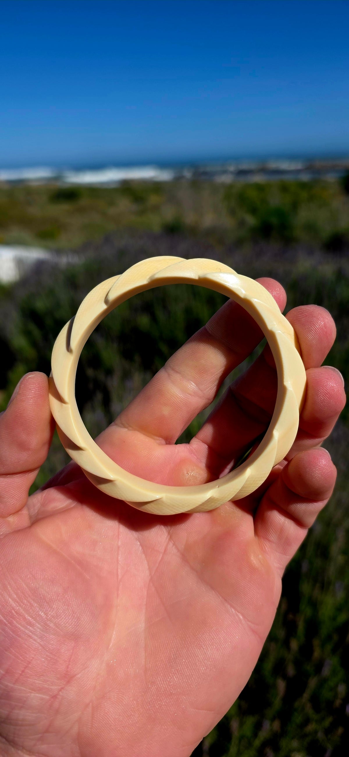 This substantial pre-ban ivory bangle has been expertly hand-carved from a single piece of ivory into a fabulous continuous twisted spiral design, creating the illusion of overlapping ribbons wrapping around the wrist.