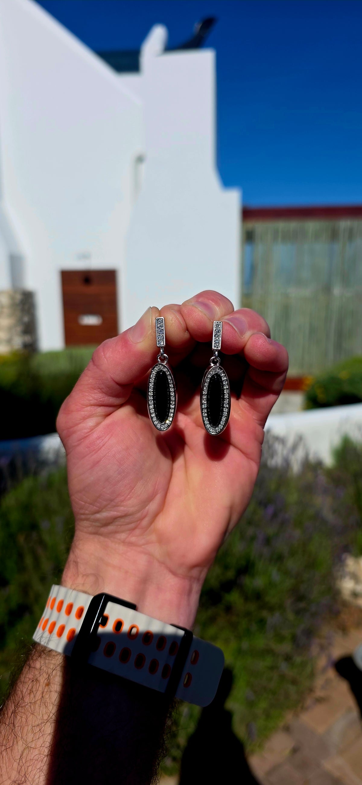 Beautifully crafted in sterling silver in a glamorous Art Deco Revival style, these high-end drop earrings have a rather clever secret — they are completely reversible!
