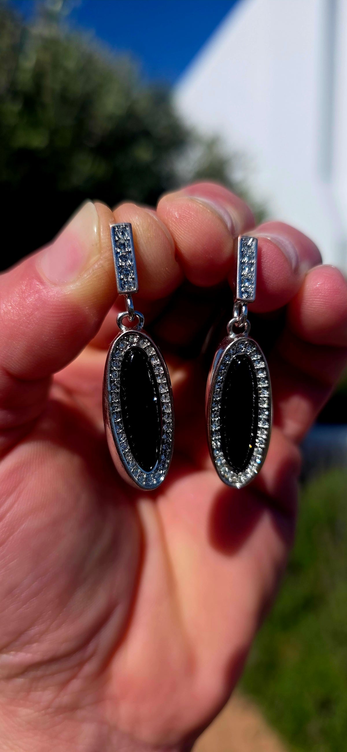 Beautifully crafted in sterling silver in a glamorous Art Deco Revival style, these high-end drop earrings have a rather clever secret — they are completely reversible!
