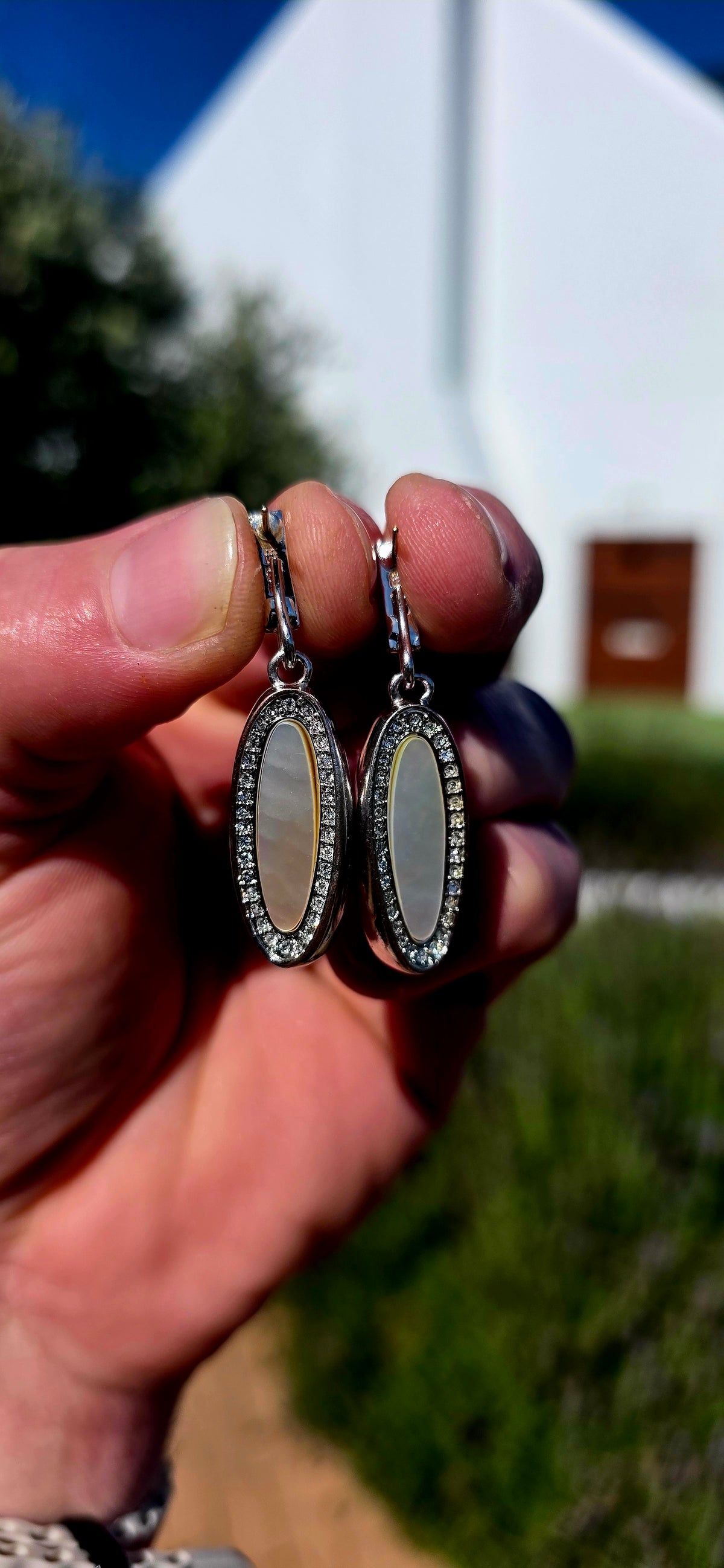 Beautifully crafted in sterling silver in a glamorous Art Deco Revival style, these high-end drop earrings have a rather clever secret — they are completely reversible!