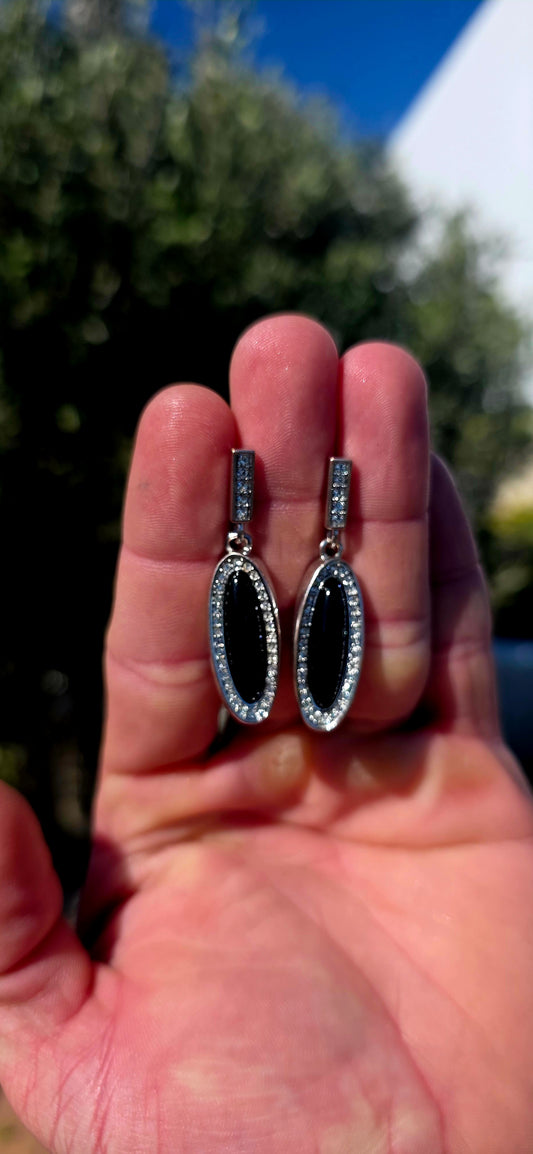 Beautifully crafted in sterling silver in a glamorous Art Deco Revival style, these high-end drop earrings have a rather clever secret — they are completely reversible!