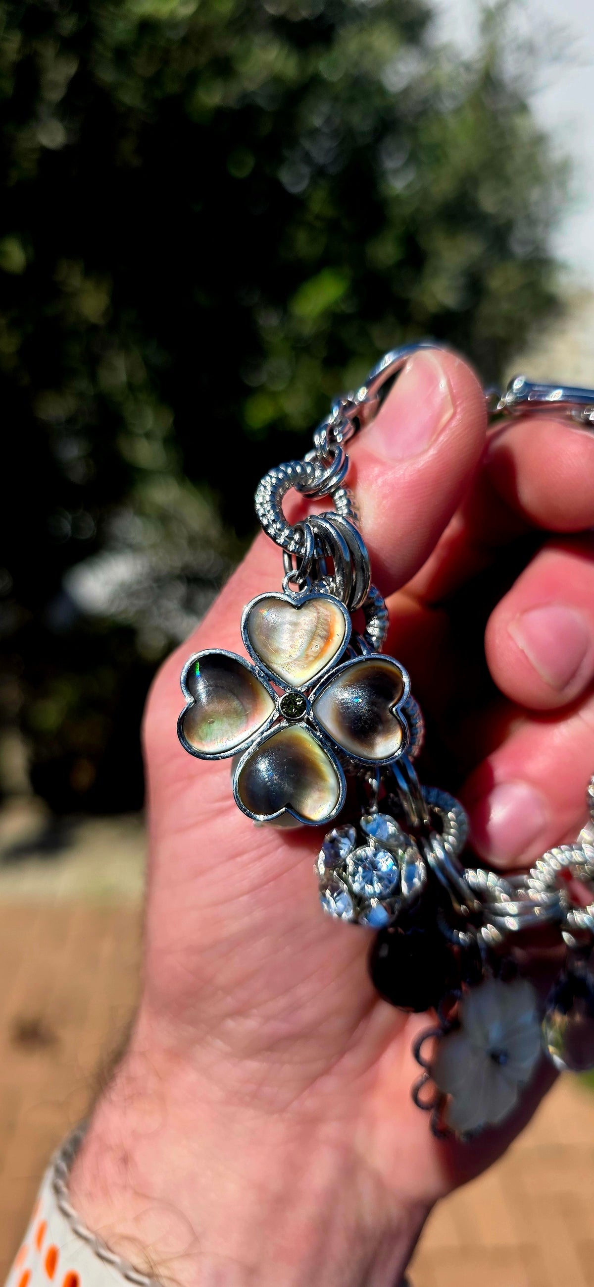 A fabulous high-quality designer costume charm bracelet by Fifth Avenue Collection, crafted in beautifully substantial silver rhodium-plated metal with an incredible mix of textures and sparkle.