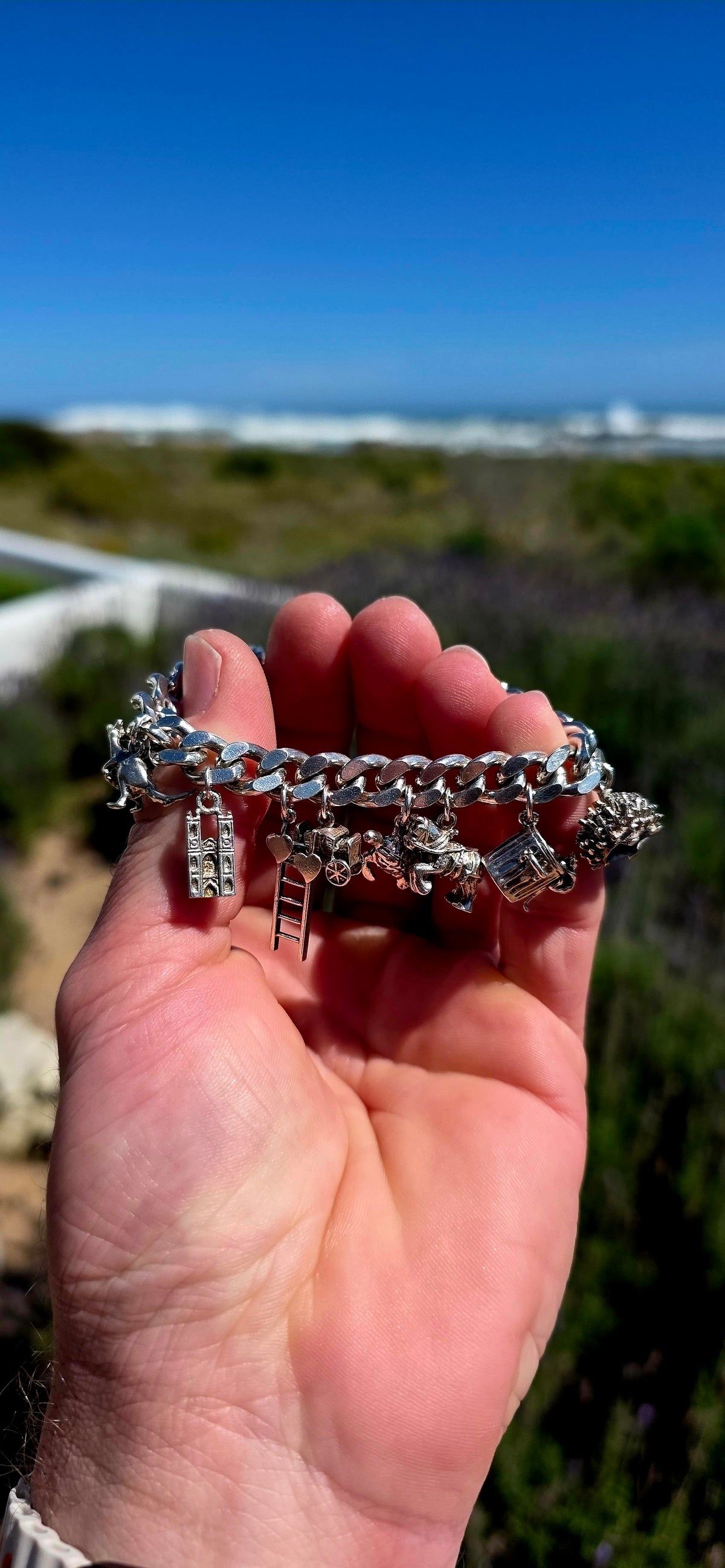 Now THIS is a proper old-school charm bracelet!! A marvellous vintage piece crafted around a beautifully substantial solid sterling silver curb-link bracelet, absolutely loaded with 13 individual sterling silver charms.