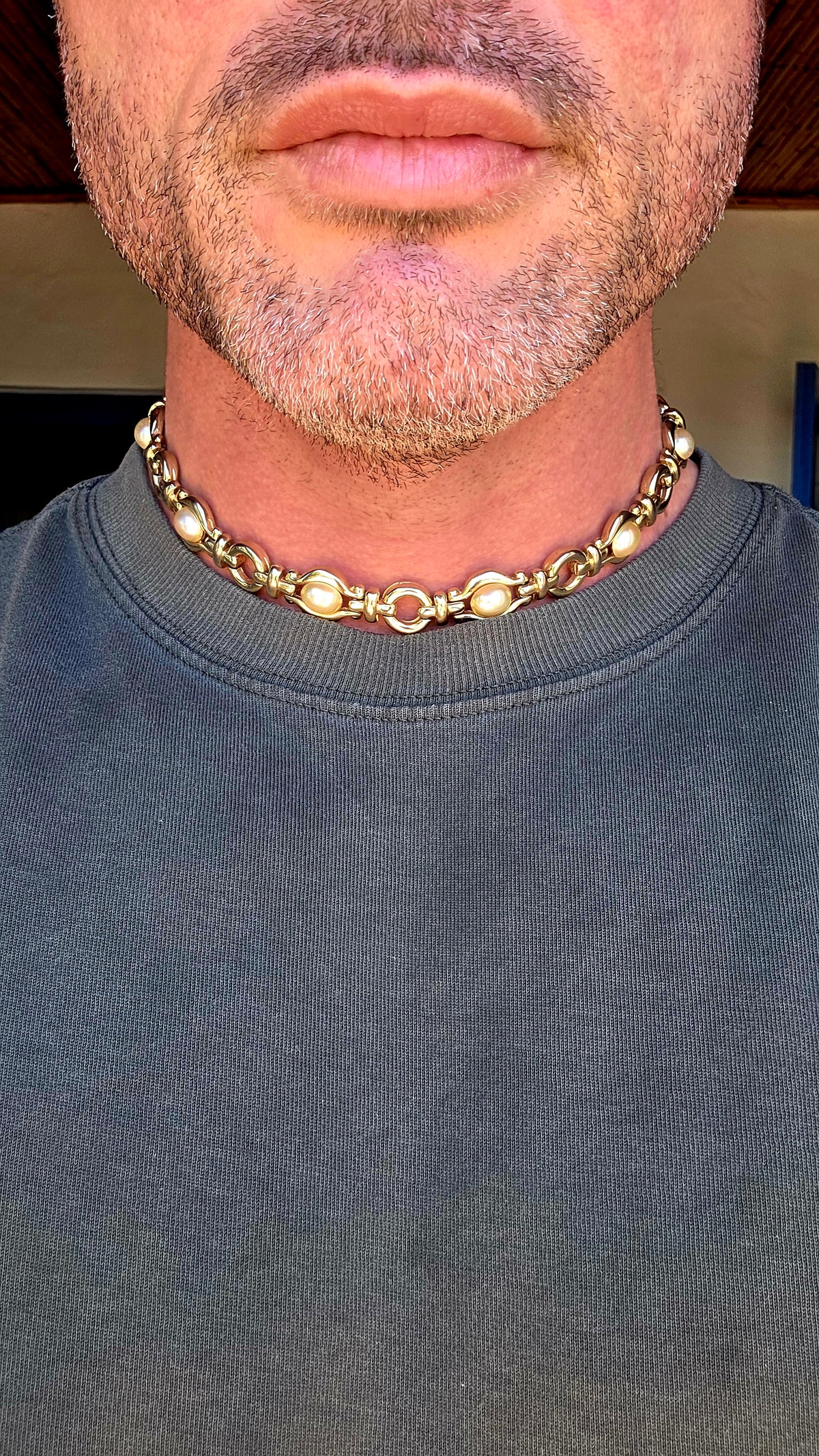 A gorgeous vintage 1990s costume necklace combining bold yellow gold-plated metalwork with beautifully lustrous oval faux pearl cabochons.