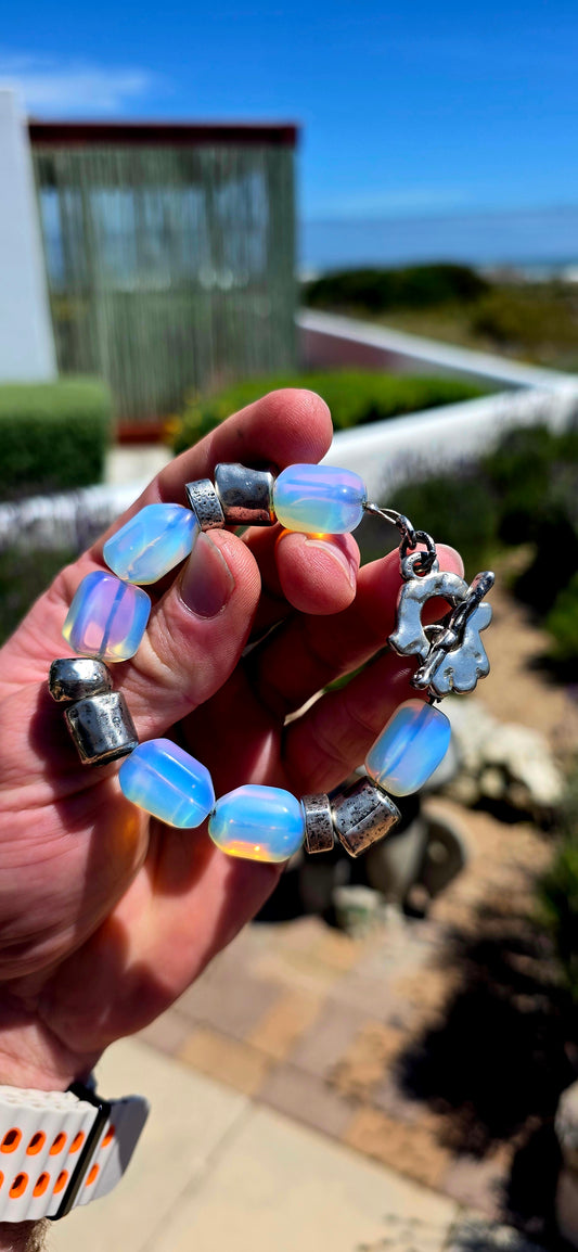 A fabulous chunky vintage designer costume bracelet by Israeli jewellery house DANON, combining sculptural silver-plated metalwork with dreamy, luminous opalite glass beads!