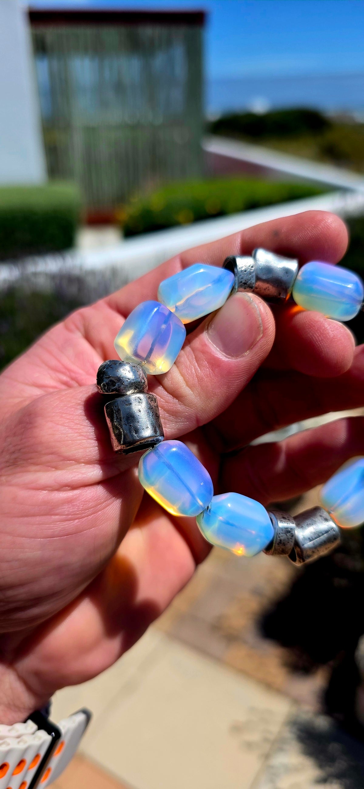 A fabulous chunky vintage designer costume bracelet by Israeli jewellery house DANON, combining sculptural silver-plated metalwork with dreamy, luminous opalite glass beads!