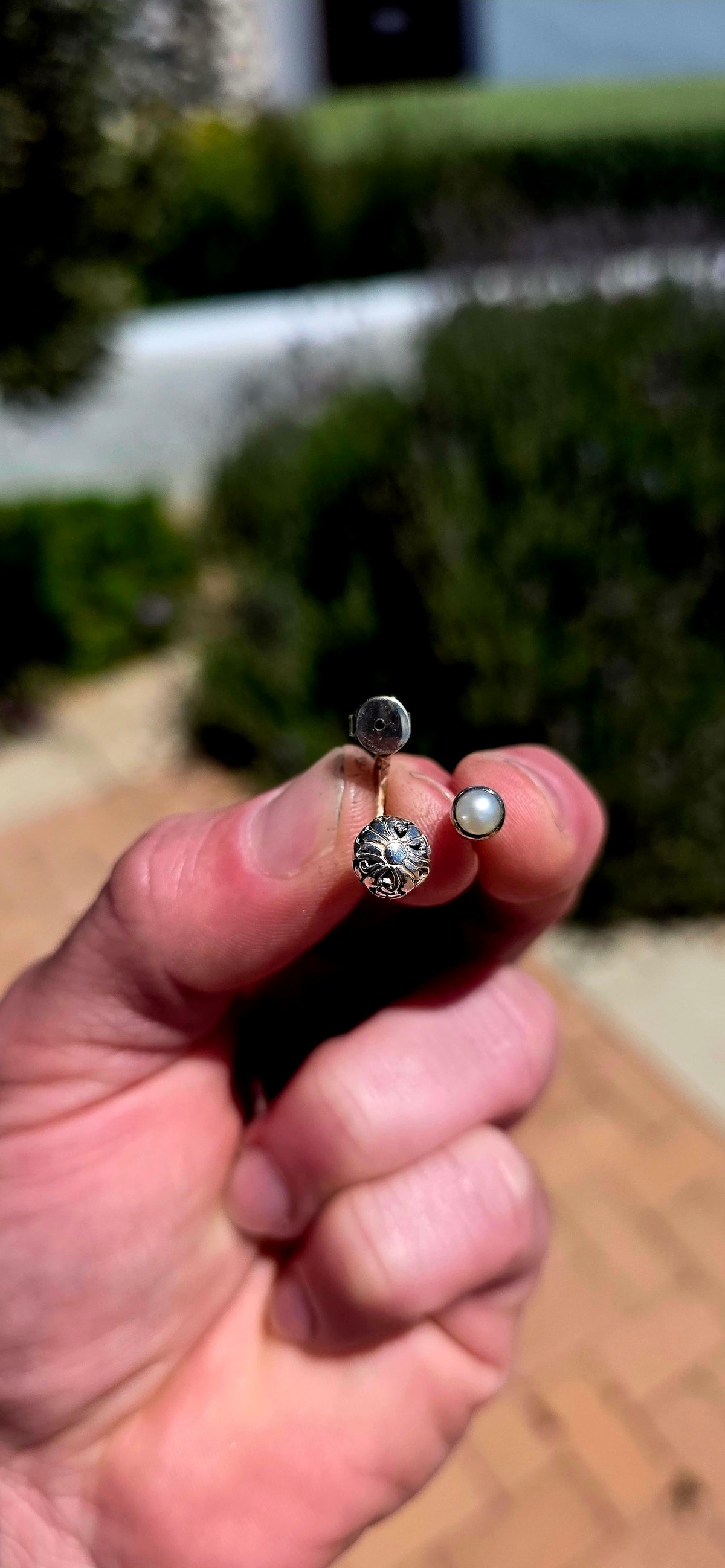 A wonderfully versatile pair of sterling silver earrings combining classical pearl elegance with beautifully detailed silver craftsmanship!