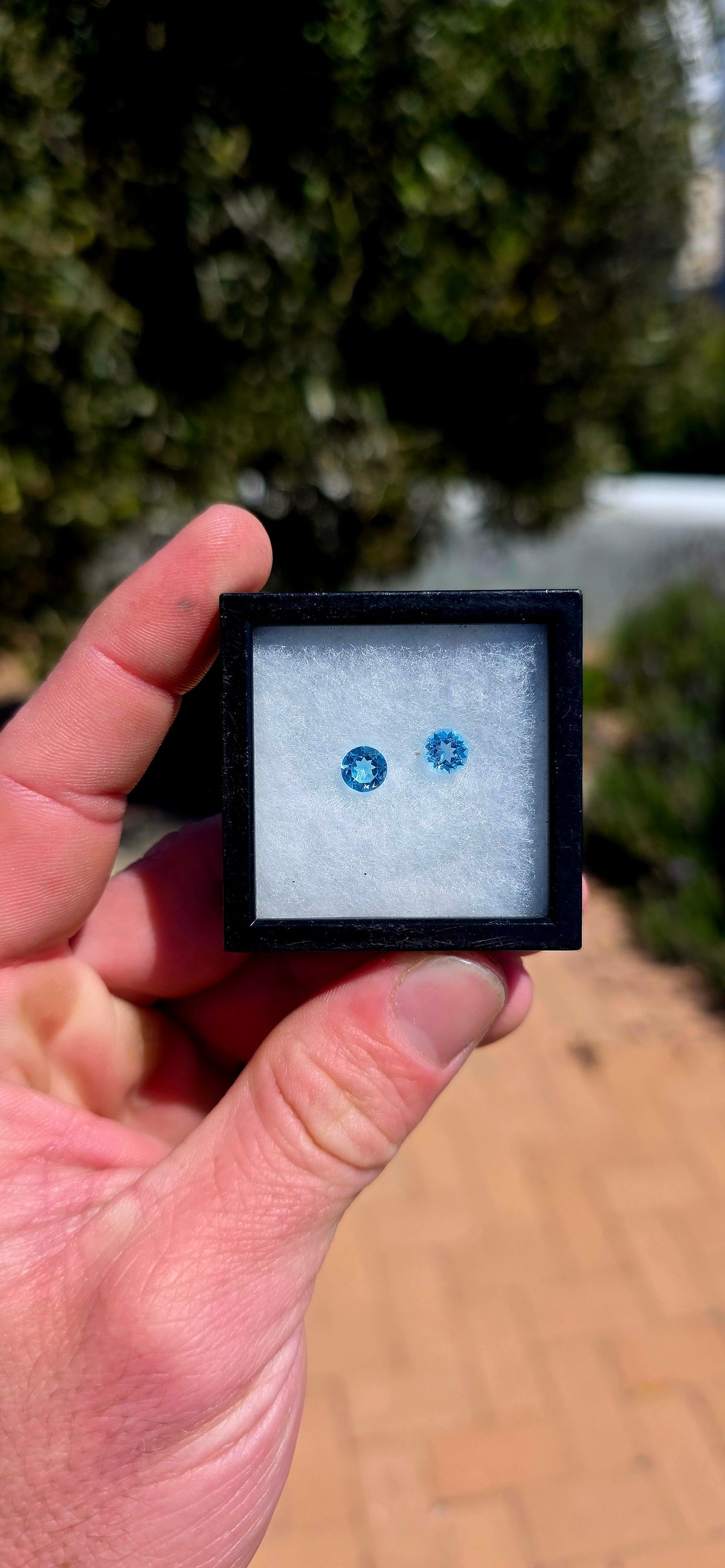 A beautiful matching pair of unset round-cut Sky Blue Topaz gemstones, displaying the most delicate, crystal-clear icy blue colour!