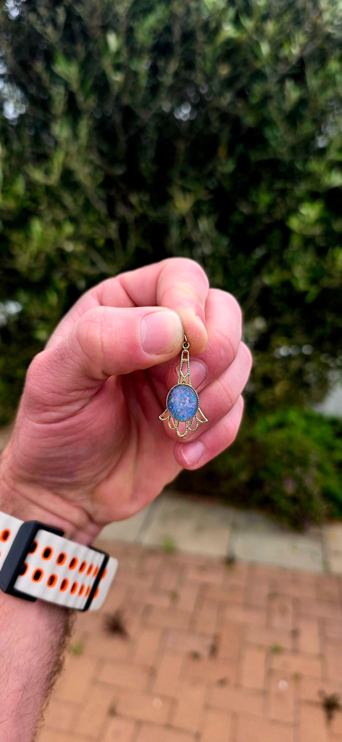A gorgeous vintage yellow gold-plated pendant featuring a mesmerising oval opal triplet cabochon, beautifully bezel-set at its centre.