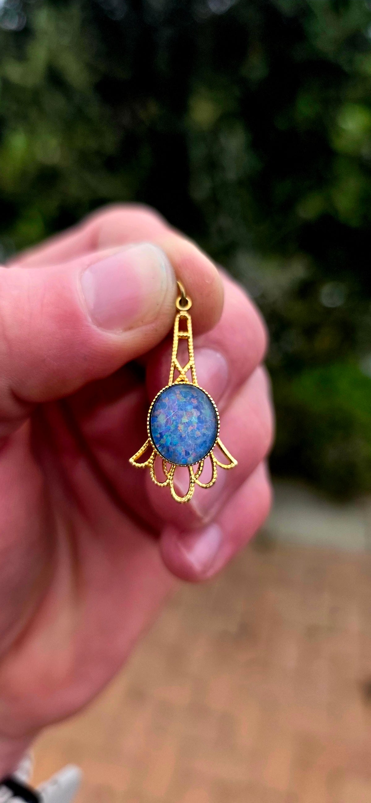 A gorgeous vintage yellow gold-plated pendant featuring a mesmerising oval opal triplet cabochon, beautifully bezel-set at its centre.