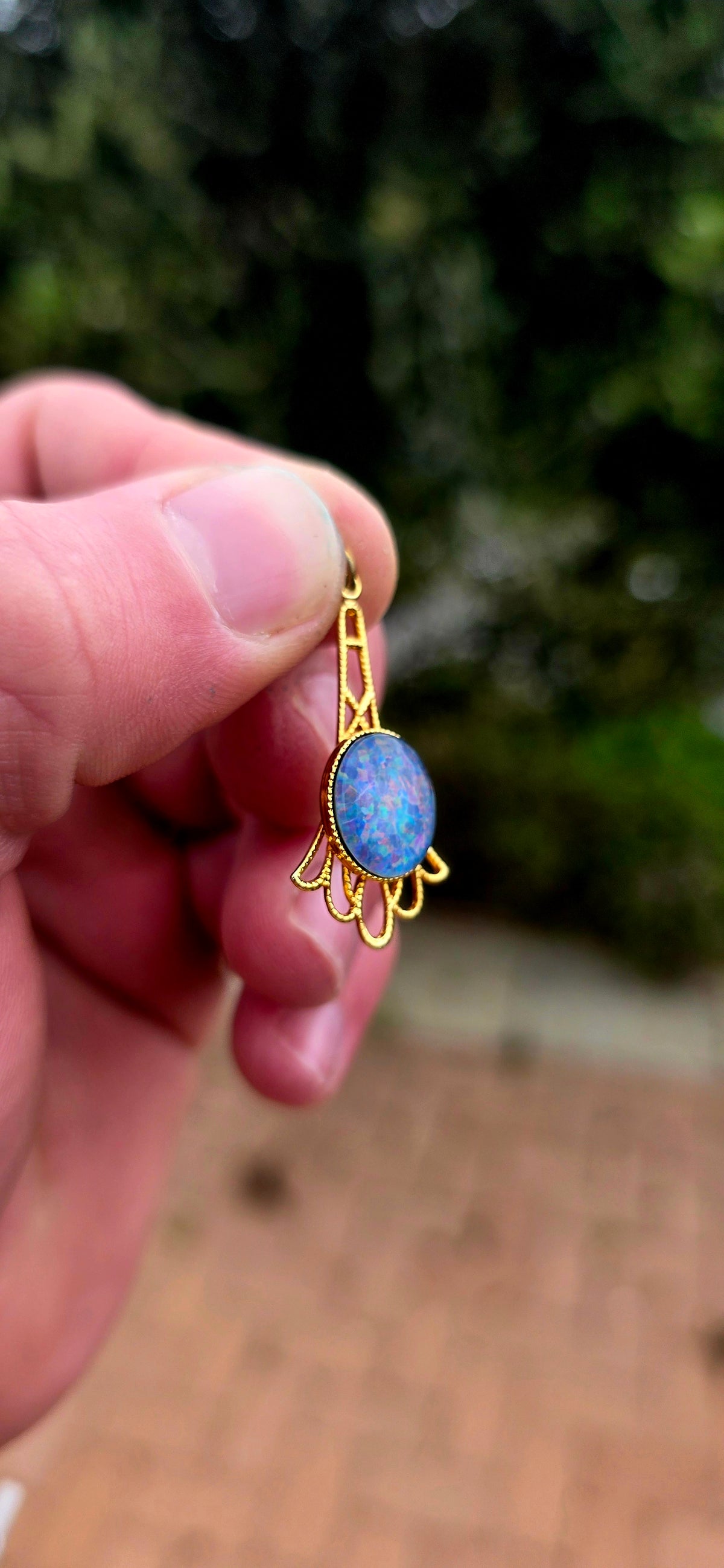 A gorgeous vintage yellow gold-plated pendant featuring a mesmerising oval opal triplet cabochon, beautifully bezel-set at its centre.