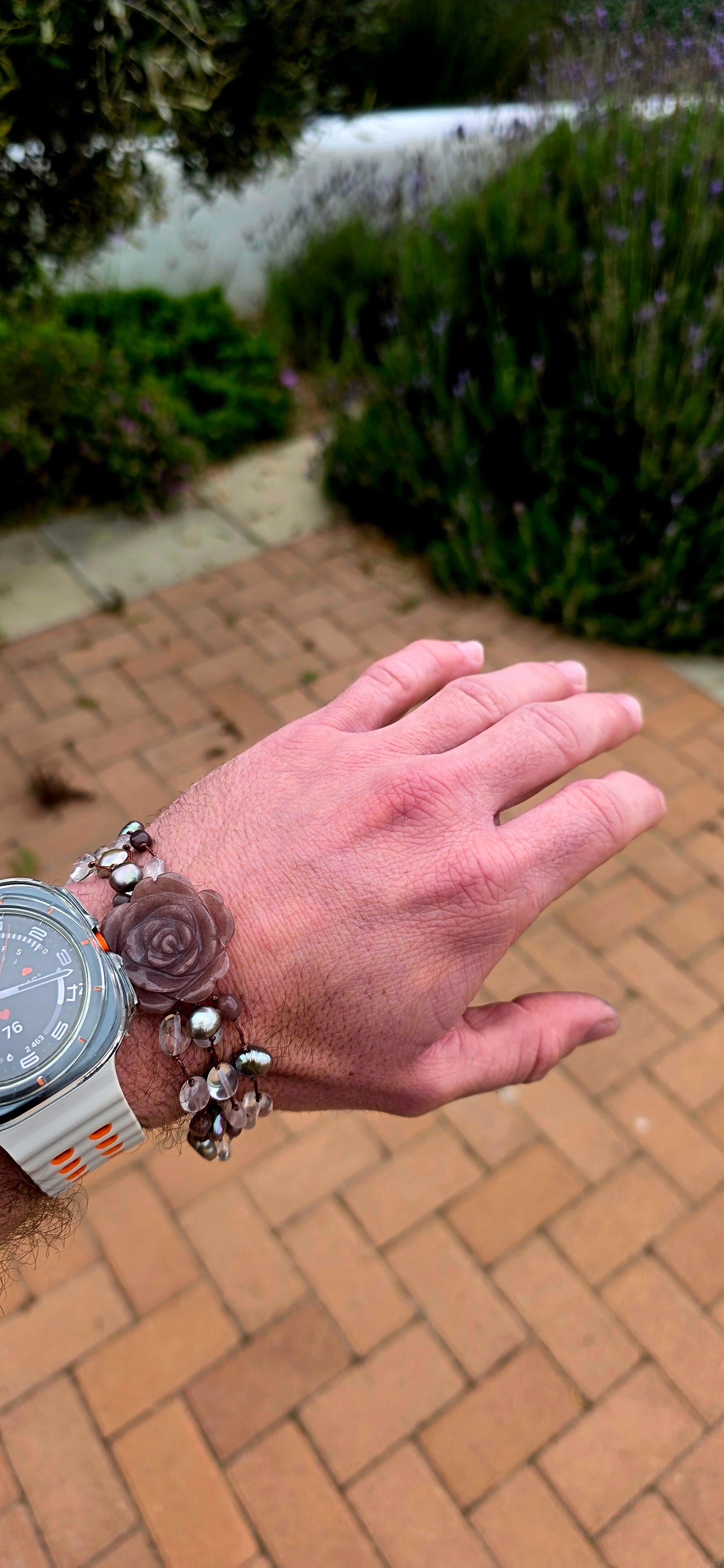A gorgeous artisan-made four-strand macramé bracelet, featuring a beautifully carved strawberry quartz gemstone rose as its magnificent centrepiece!