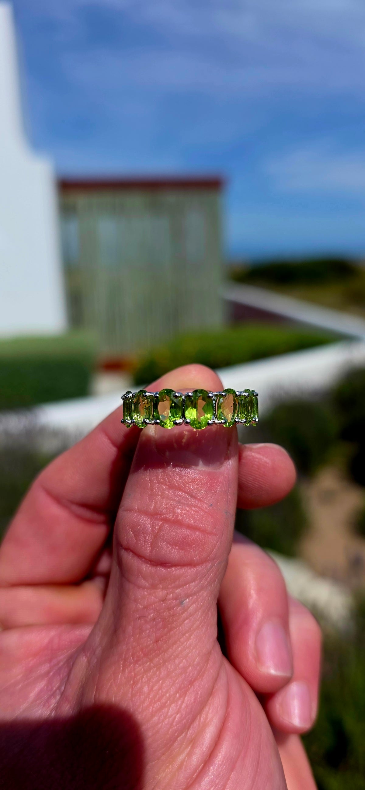 A gorgeous Sterling Silver Full Eternity Ring, beautifully set with 14 generously sized, oval-cut natural peridot gemstones, each individually prong-set to create an uninterrupted circle of sparkling lime-green brilliance!