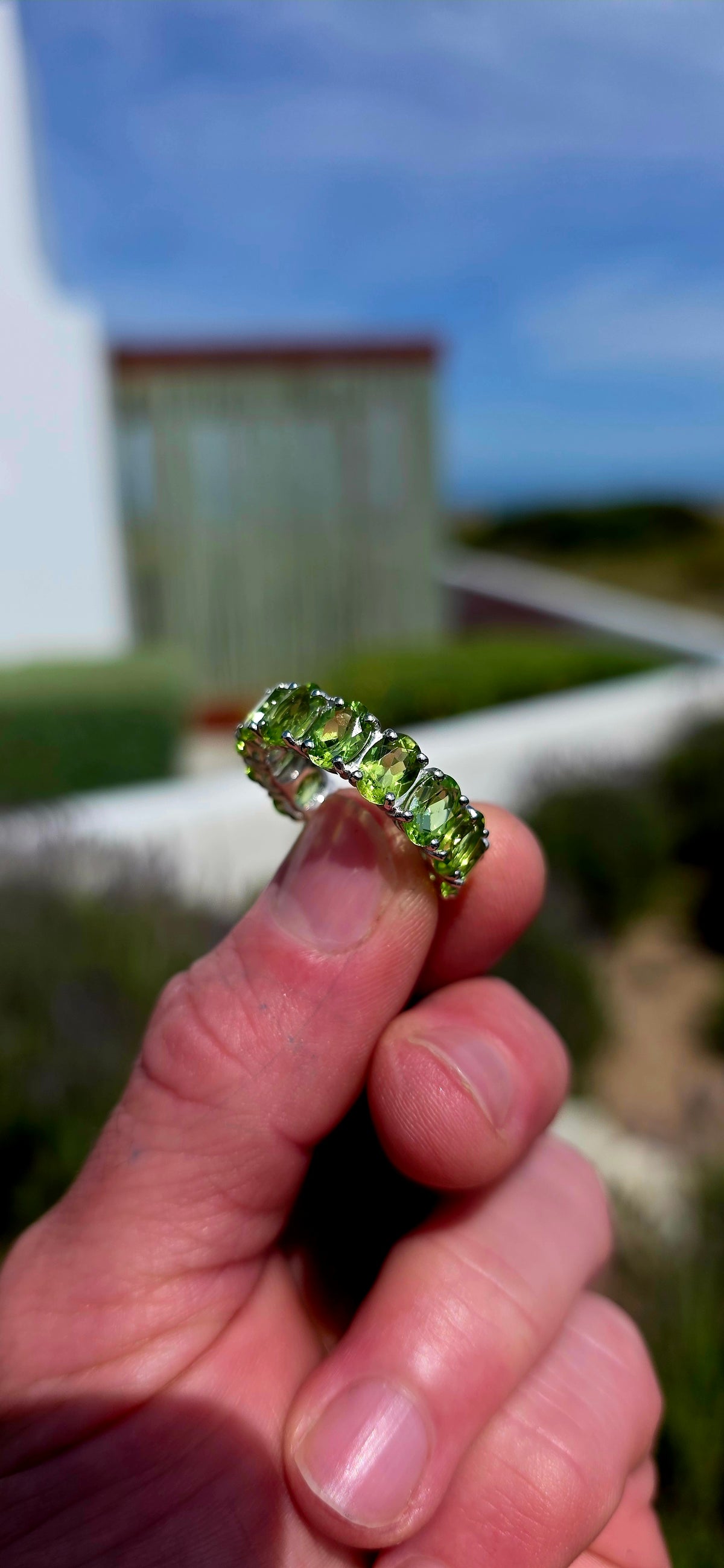 A gorgeous Sterling Silver Full Eternity Ring, beautifully set with 14 generously sized, oval-cut natural peridot gemstones, each individually prong-set to create an uninterrupted circle of sparkling lime-green brilliance!