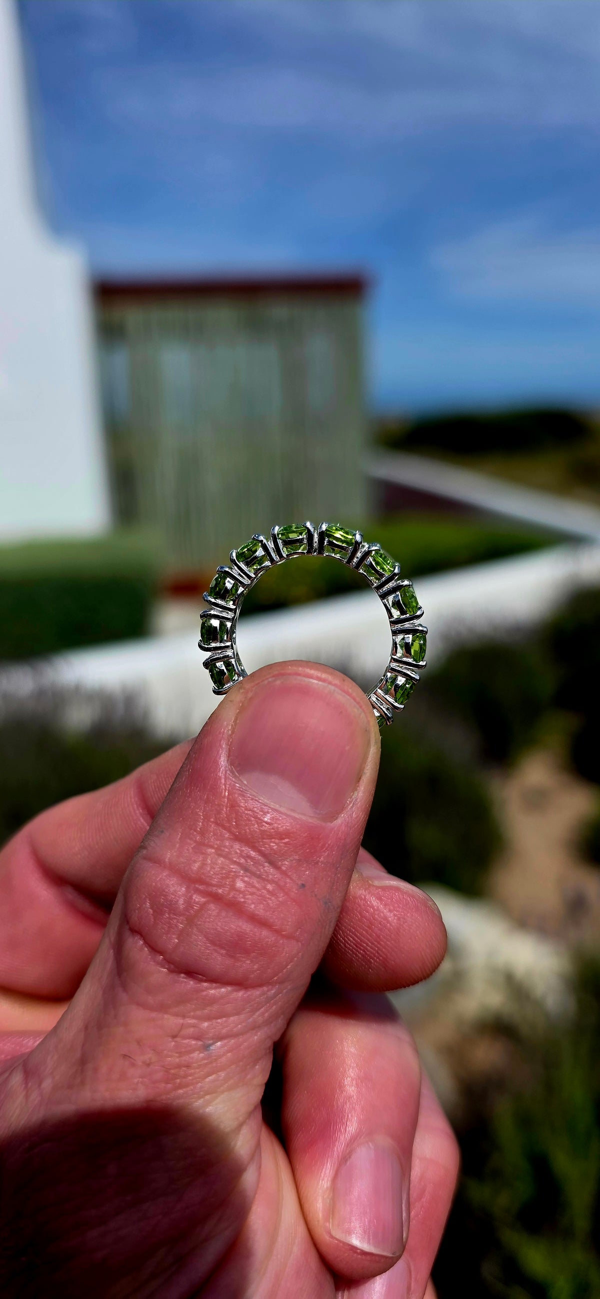 A gorgeous Sterling Silver Full Eternity Ring, beautifully set with 14 generously sized, oval-cut natural peridot gemstones, each individually prong-set to create an uninterrupted circle of sparkling lime-green brilliance!