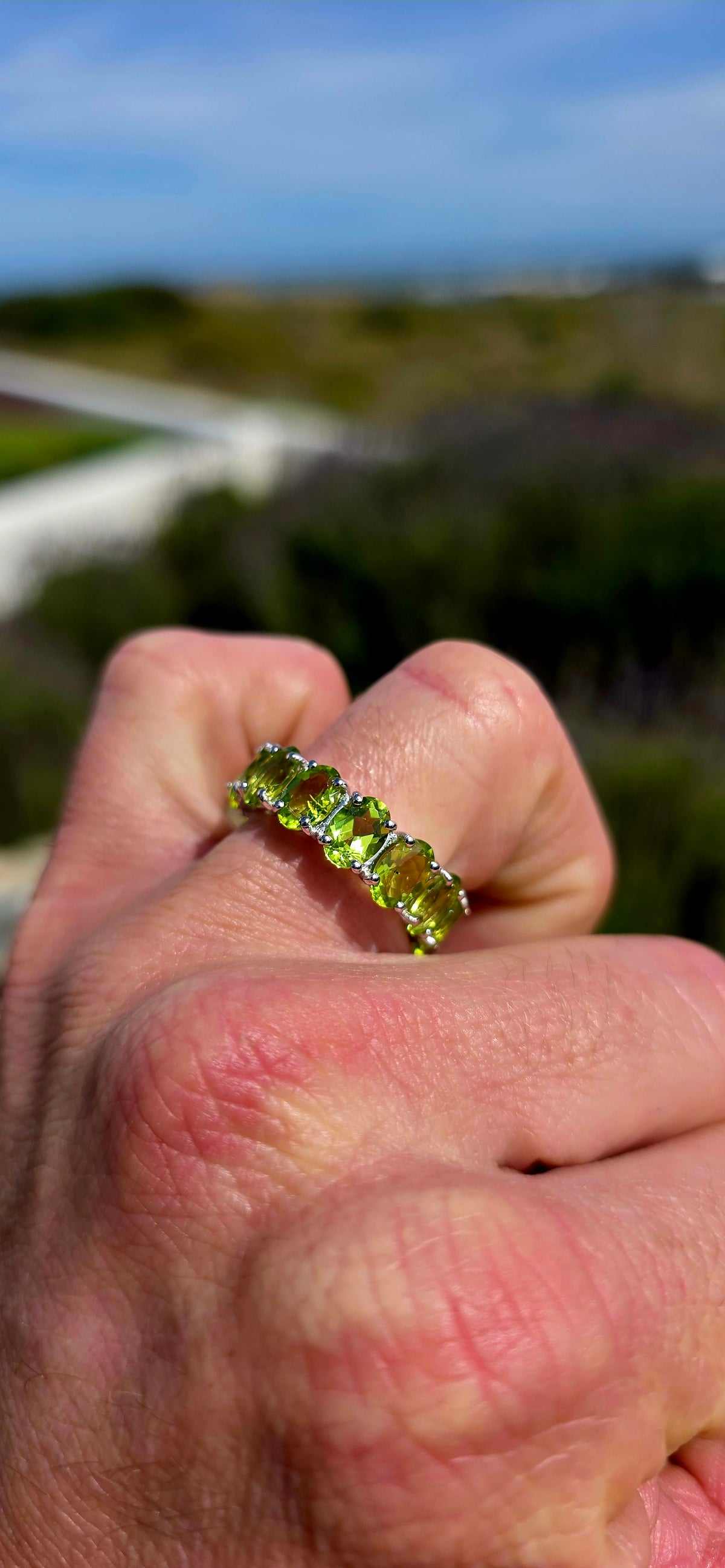A gorgeous Sterling Silver Full Eternity Ring, beautifully set with 14 generously sized, oval-cut natural peridot gemstones, each individually prong-set to create an uninterrupted circle of sparkling lime-green brilliance!