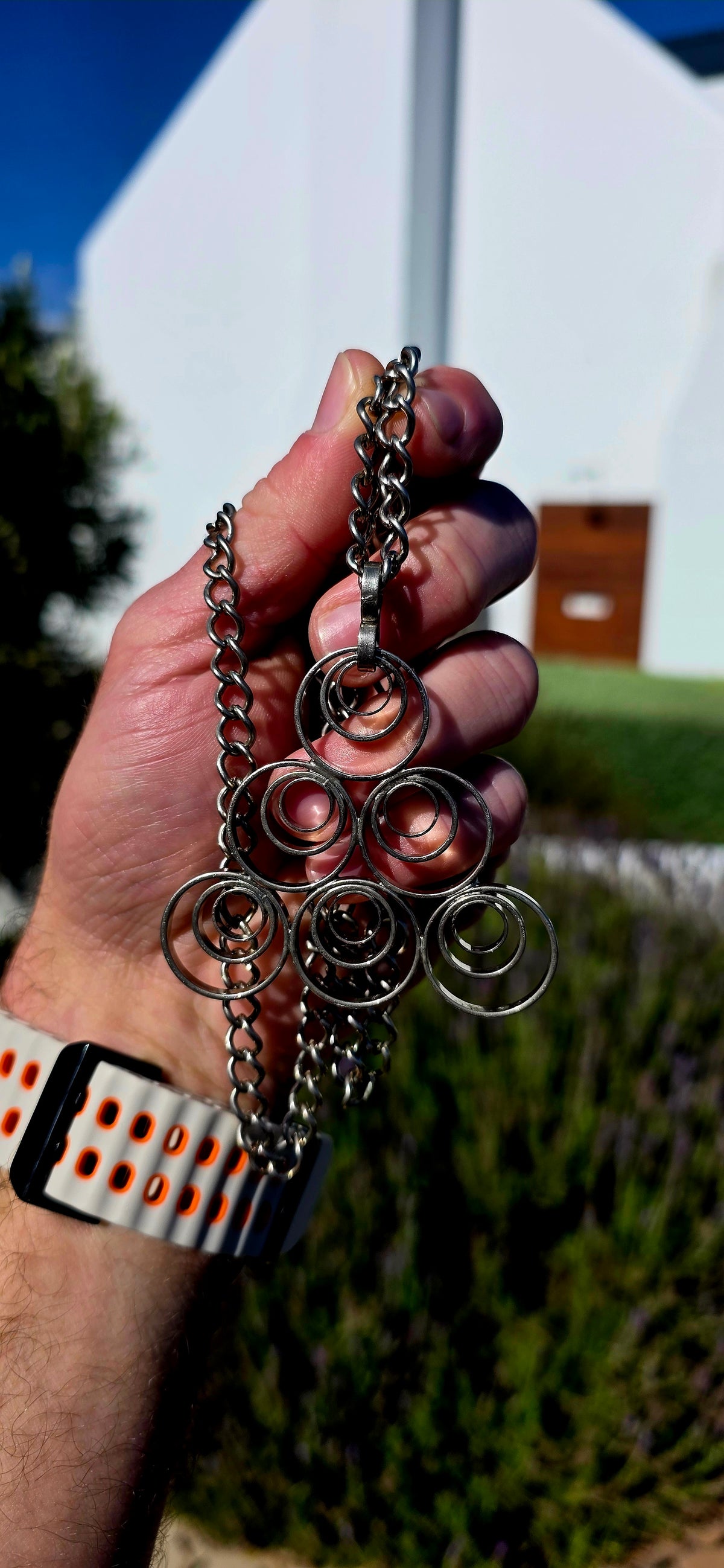 A striking vintage modernist studio-made necklace, featuring a generously sized, sculptural silvertone pendant suspended from an extra-length chain!
