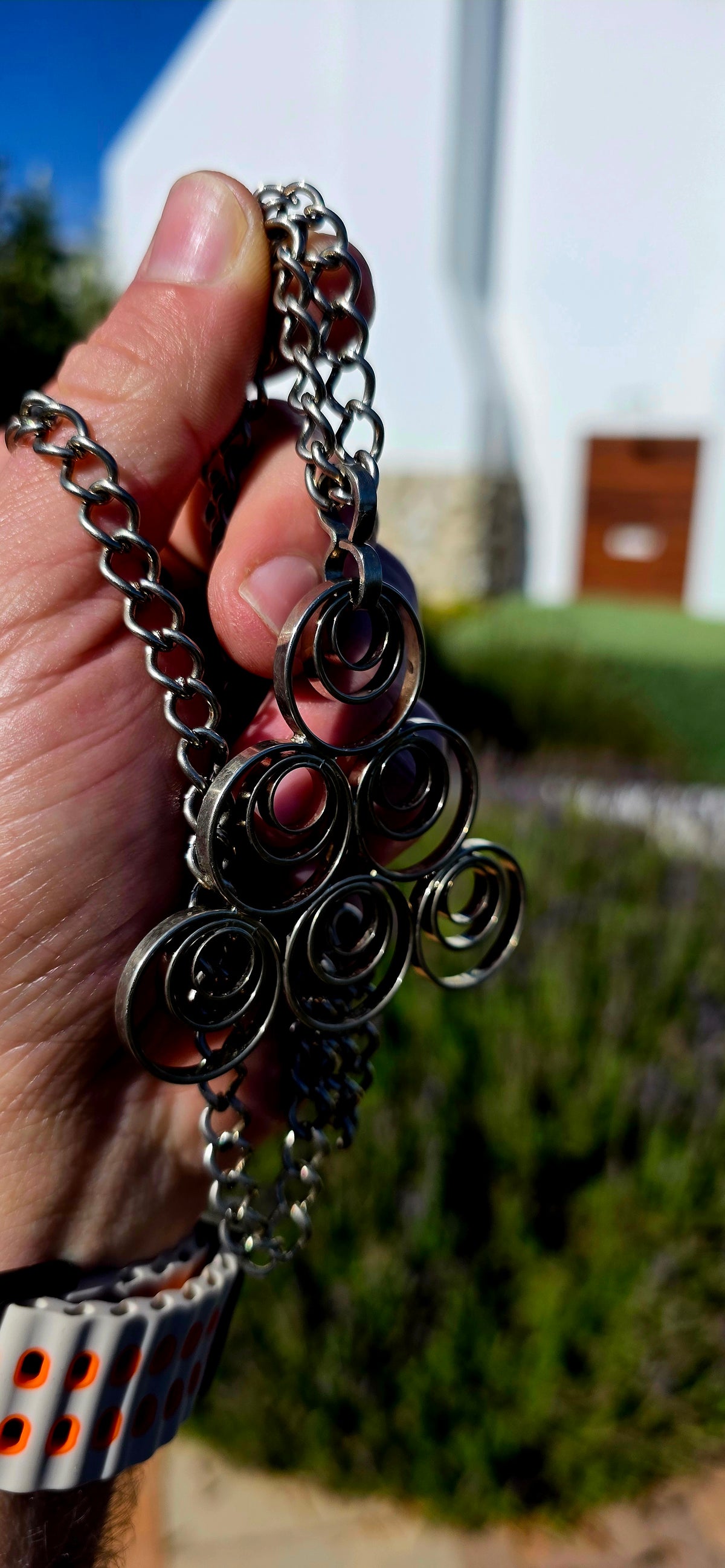 A striking vintage modernist studio-made necklace, featuring a generously sized, sculptural silvertone pendant suspended from an extra-length chain!