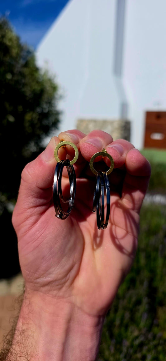 A generously sized pair of artisan-made sterling silver statement earrings, combining bold geometric design with a fabulous contrast of gold and oxidised black silver!
