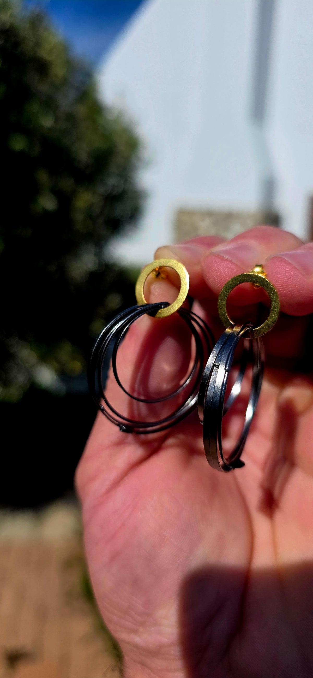 A generously sized pair of artisan-made sterling silver statement earrings, combining bold geometric design with a fabulous contrast of gold and oxidised black silver!