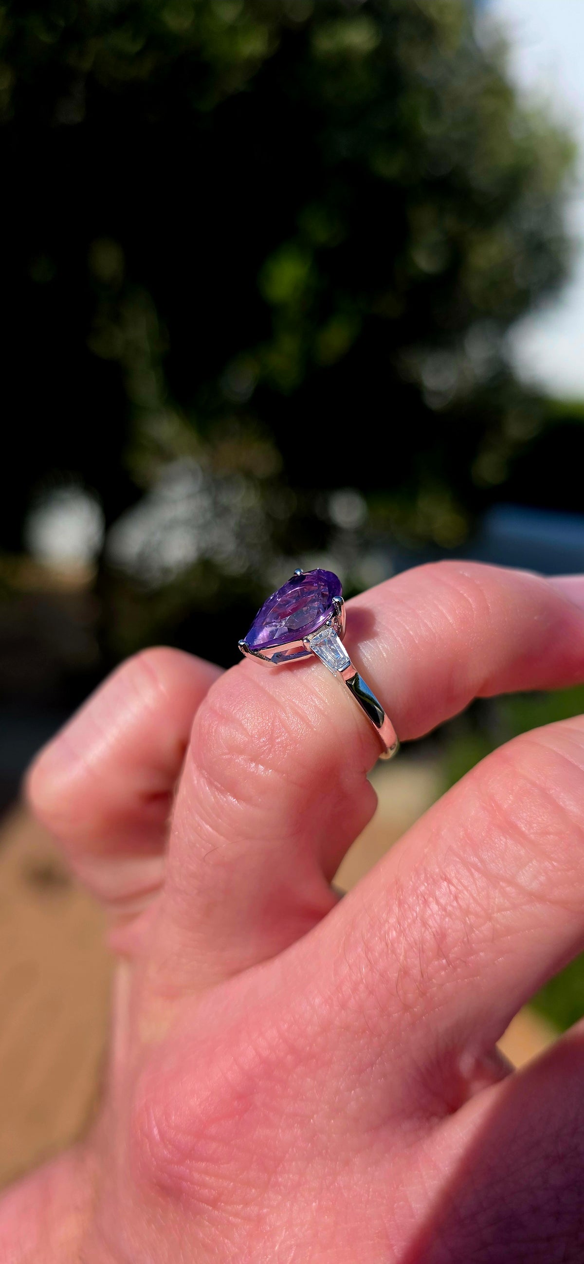 A gorgeous sterling silver trilogy ring, beautifully designed in an Art Deco revival style with a fabulous splash of purple!