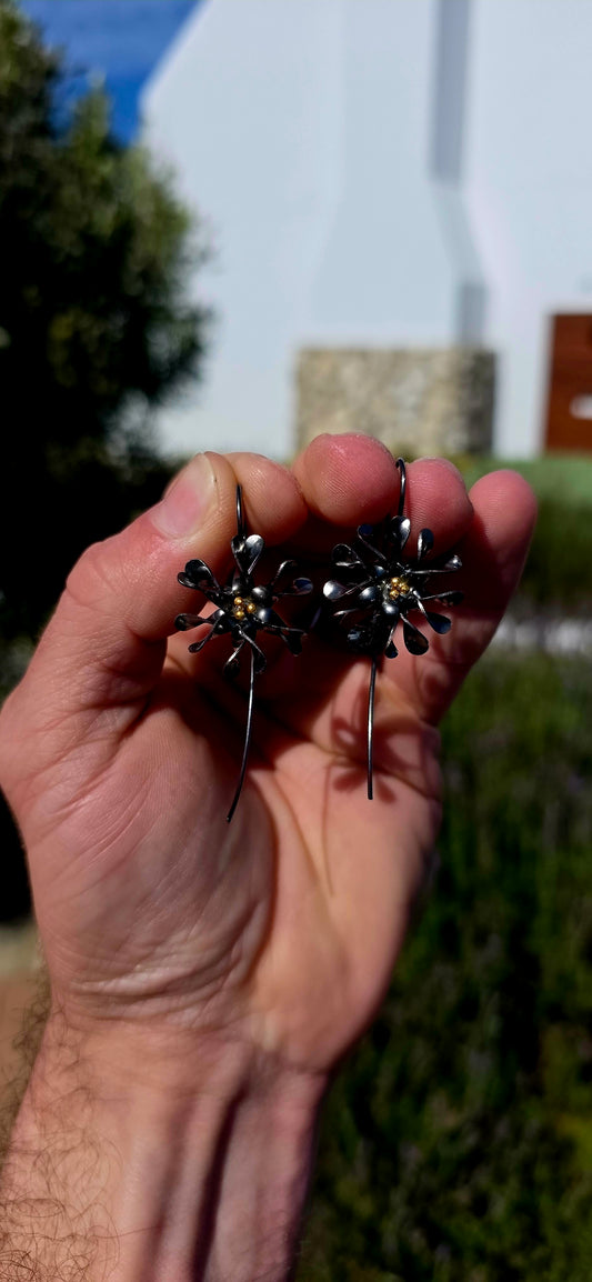 A wonderfully artistic pair of artisan-crafted sterling silver statement earrings, bringing together delicate floral beauty and bold, contemporary design!