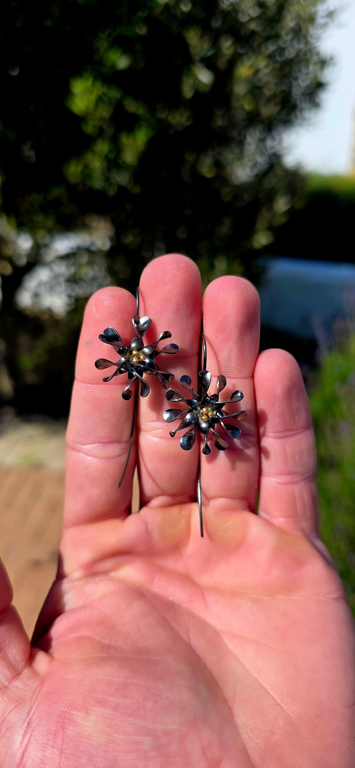 A wonderfully artistic pair of artisan-crafted sterling silver statement earrings, bringing together delicate floral beauty and bold, contemporary design!